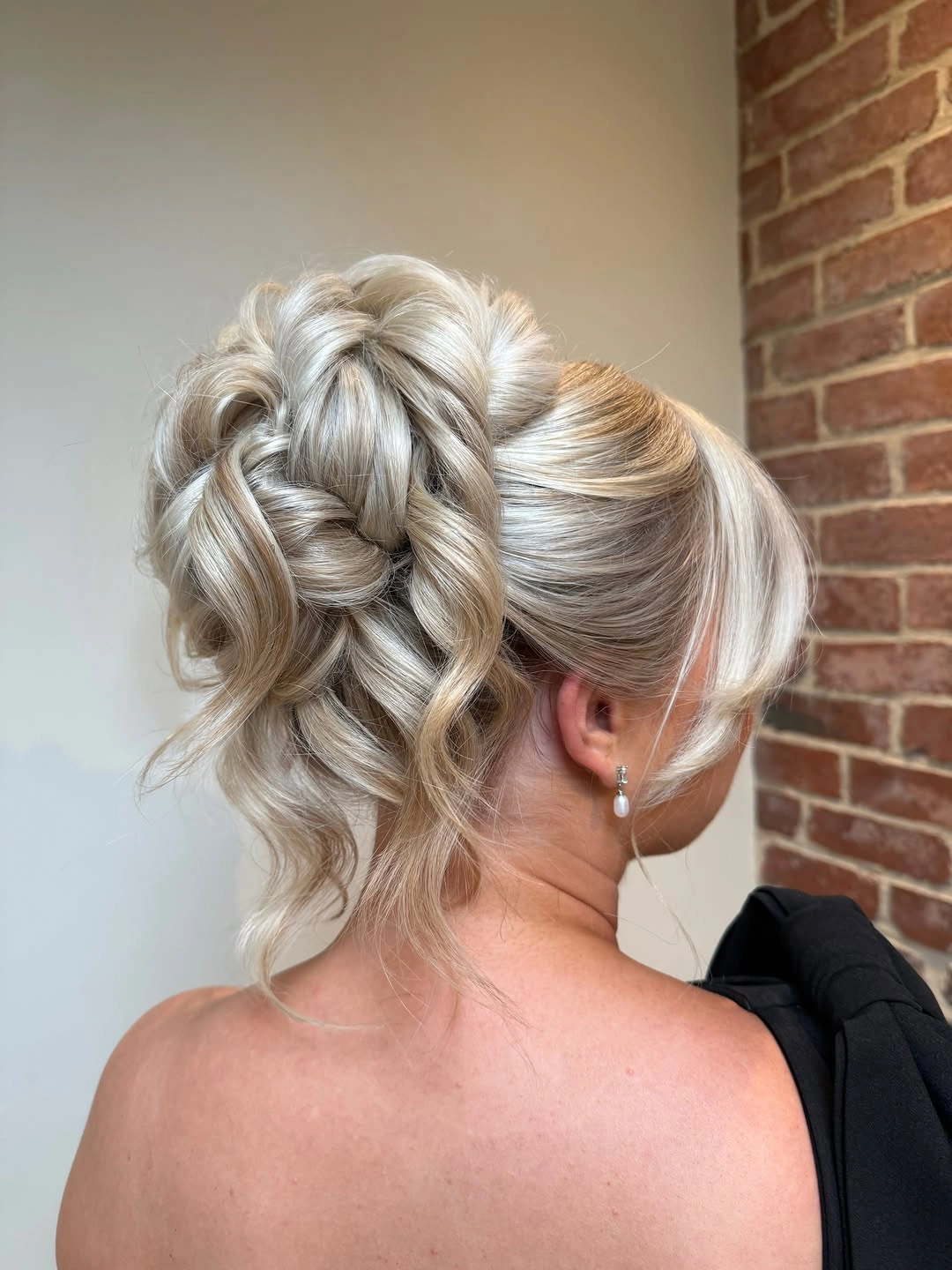 bridesmaid hairstyling Voluminous Blonde Updo With Soft Texture