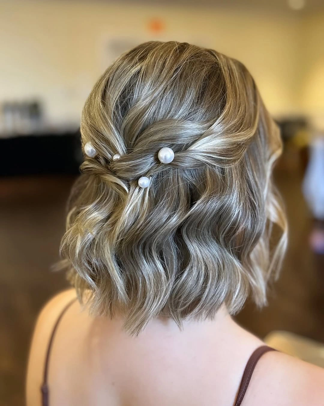 bridesmaid hairstyling Half Up Waves With Delicate Pearl Details
