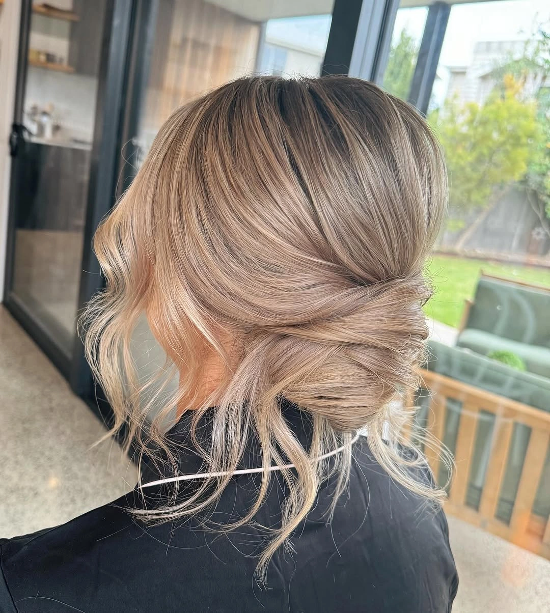 bridesmaid hairstyling Soft Twisted Low Chignon With Airy Texture