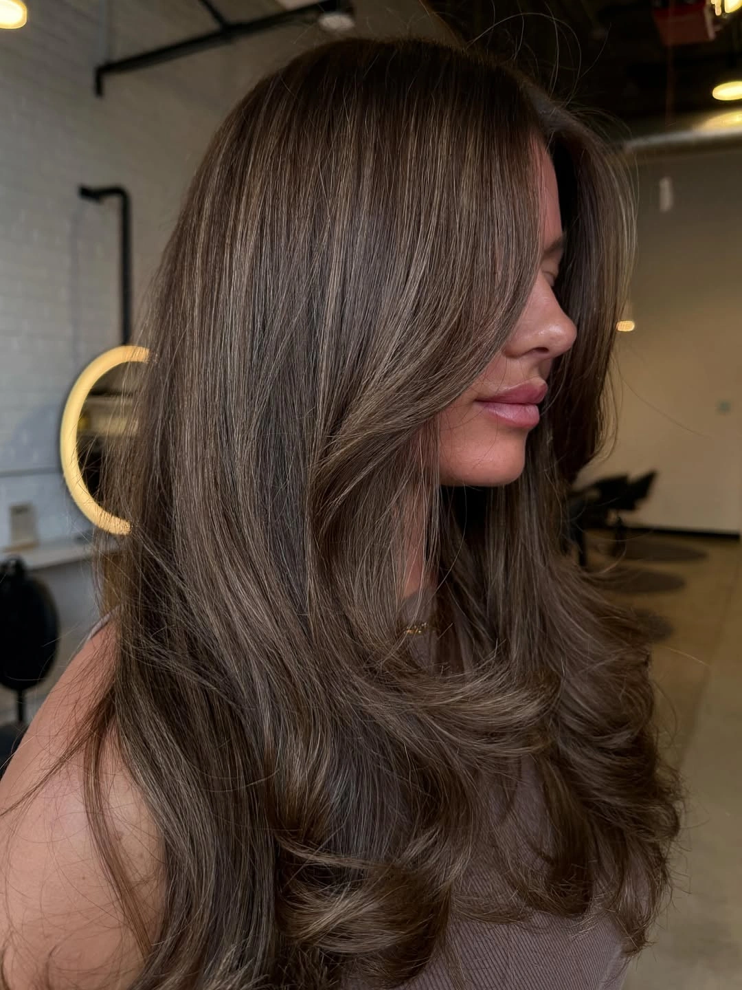 dimensional brunette hair color Smoky Mushroom Brunette With Silky Layers