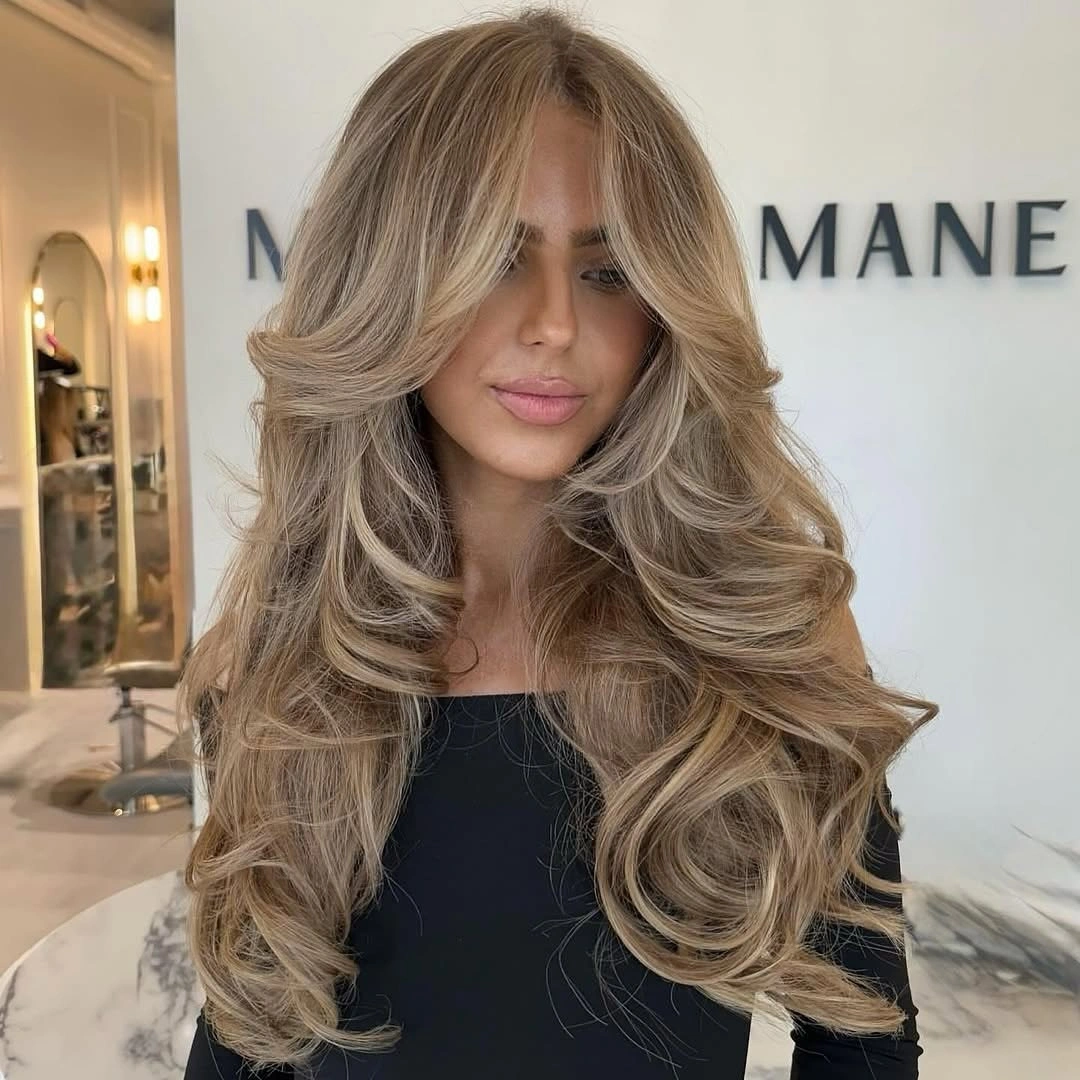 dirty blonde hair color Voluminous Dirty Blonde with Feathered Layers