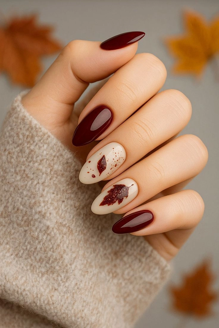 Fall almond nails 2026 Minimal Burgundy Leaves for a Cozy Autumn Look