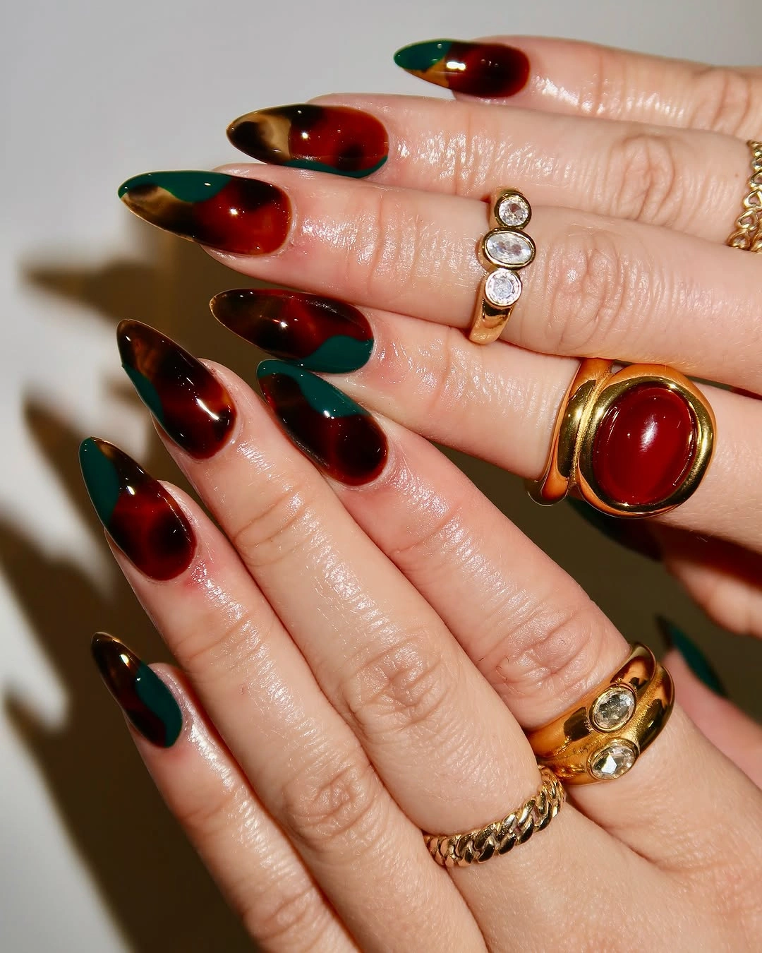 Fall almond nails 2026 Abstract Green and Amber Glass Nails