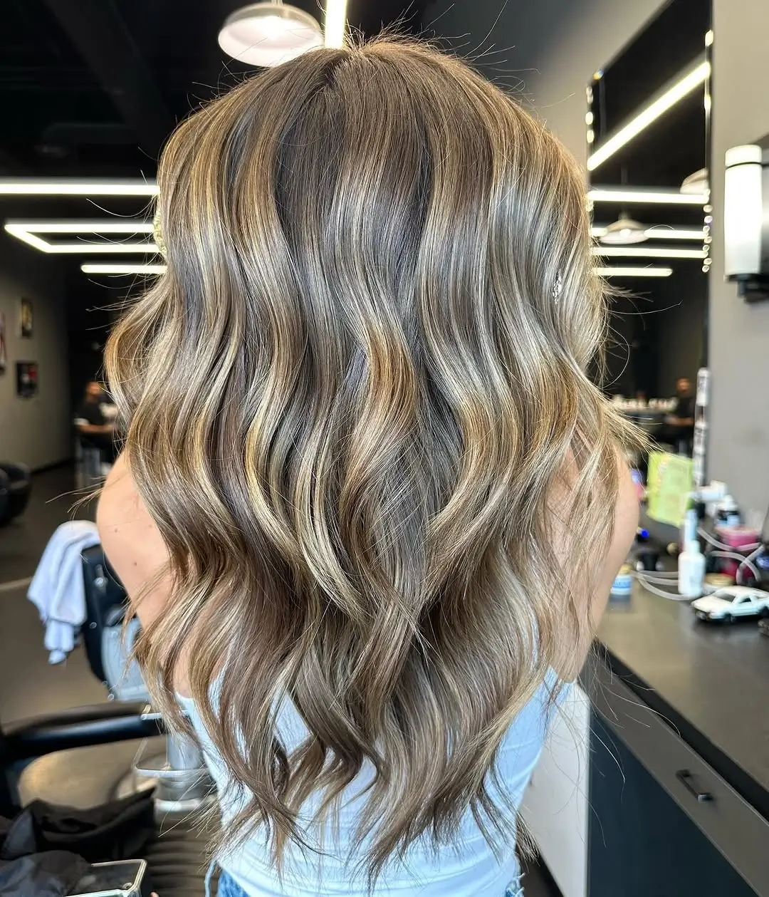 Fall blonde hair colour 2026 Cool Mushroom Blonde With Glossy Soft Waves