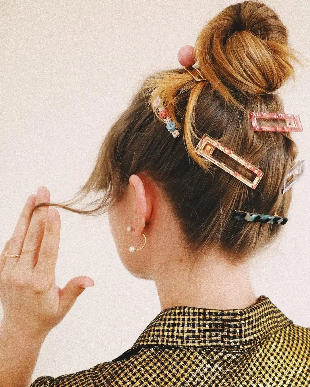 fall hairstyles 2026 Playful Messy Bun with Colorful Statement Clips