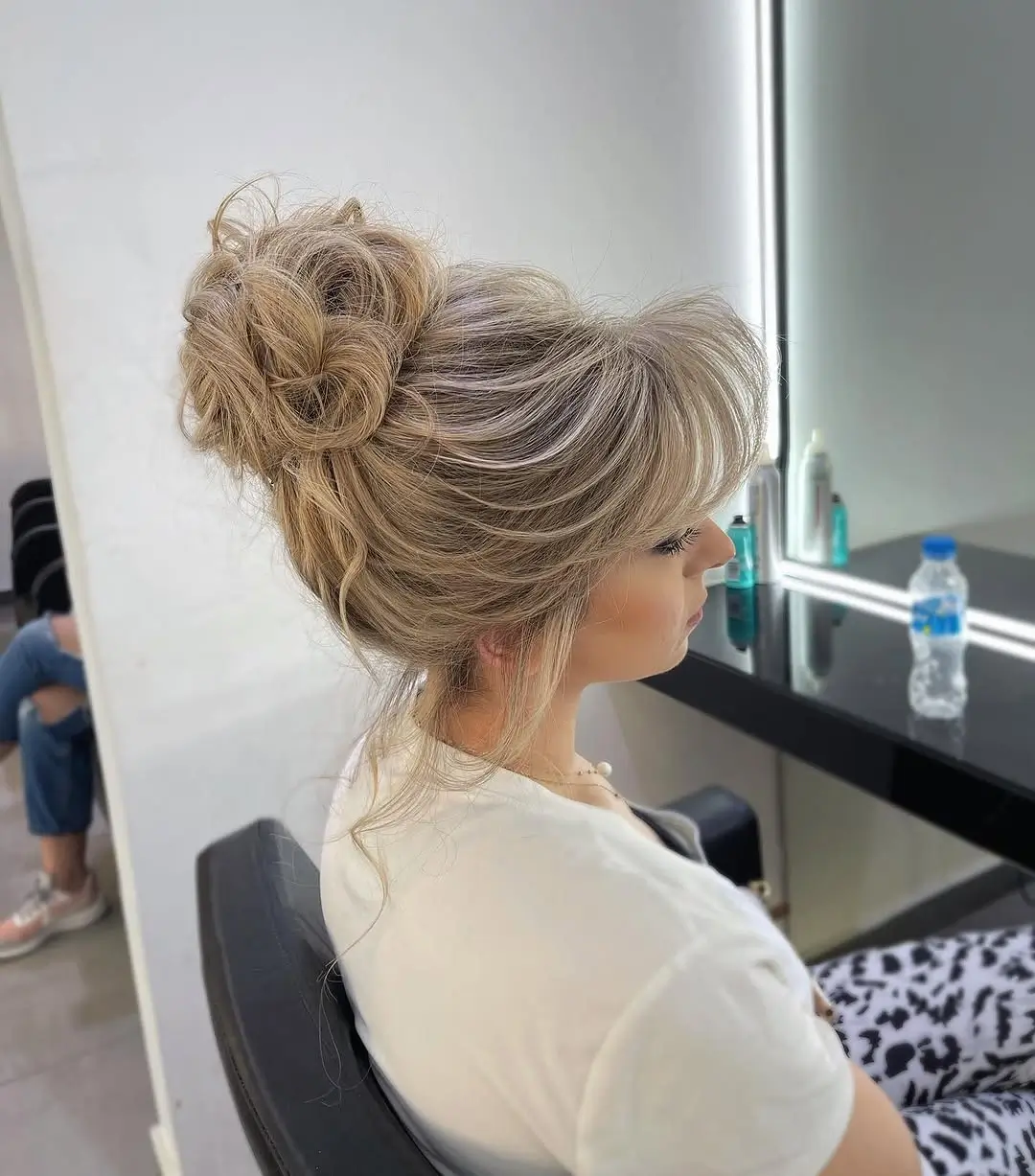 fall hairstyles for long hair 2026 Elegant Textured Bun With Soft Face Framing Layers