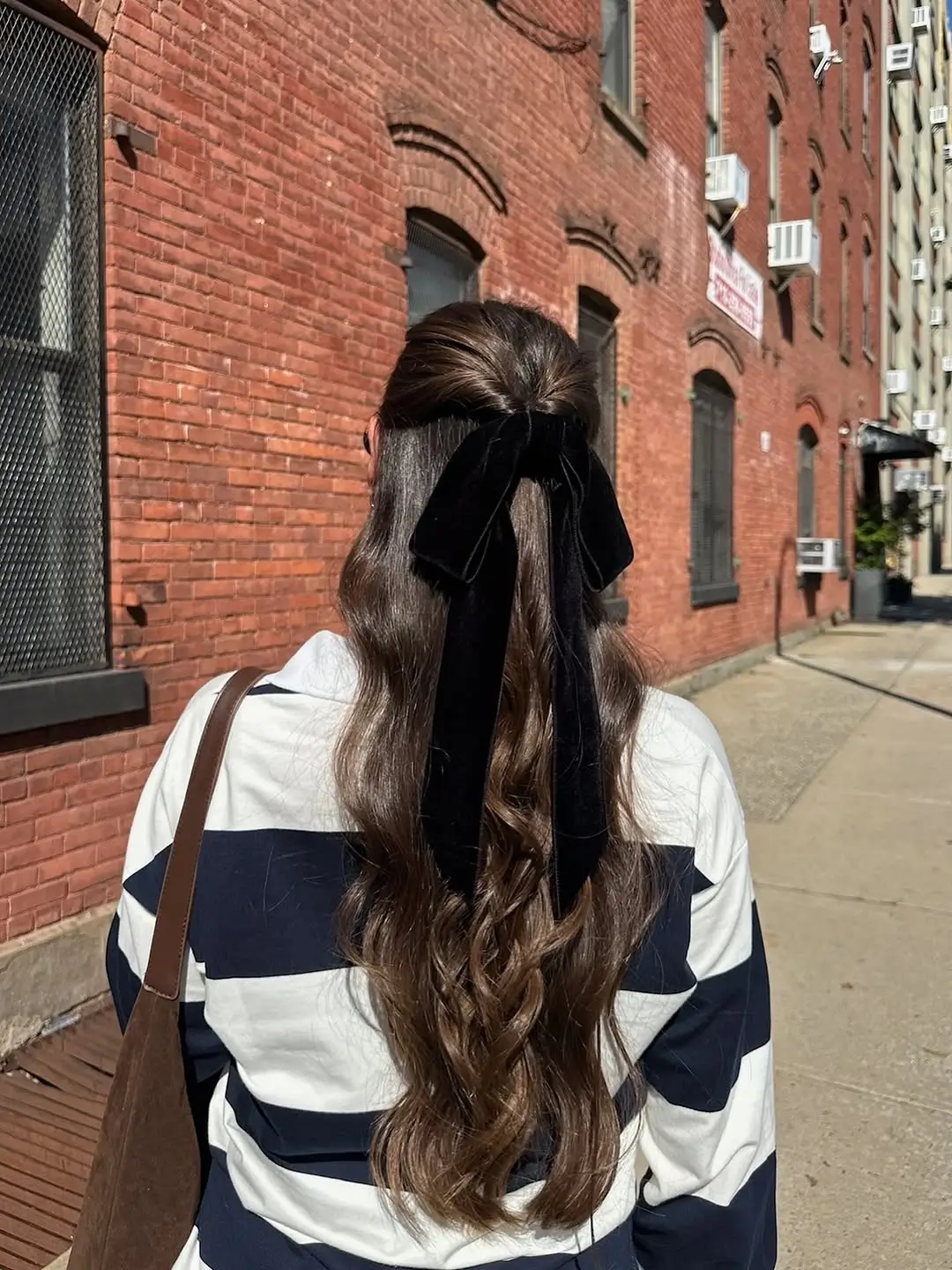 fall hairstyles for long hair 2026 Half Up Brunette Waves Finished With a Velvet Bow