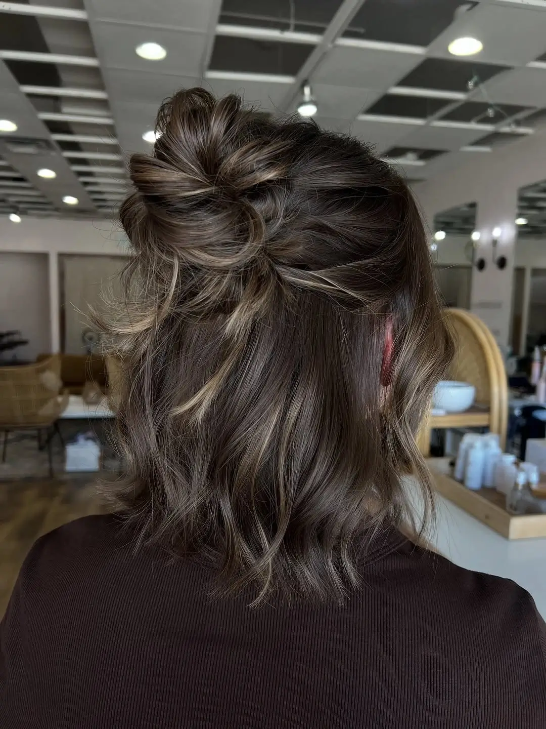 Fall hairstyles for short hair 2026 A Textured Mini Bun That Gives Short Hair Endless Possibilities