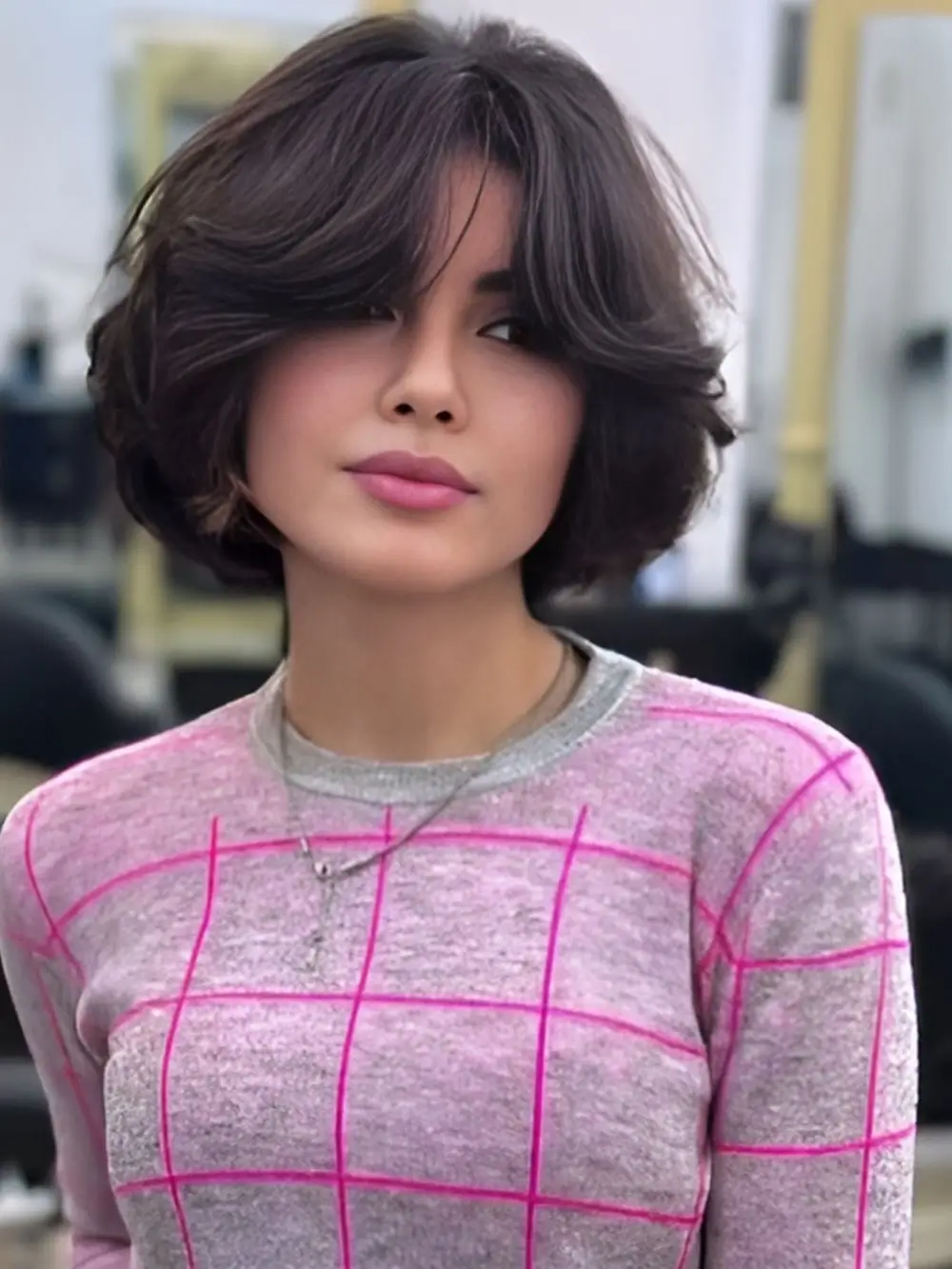 Fall hairstyles for short hair 2026 A Rounded Layered Bob With Soft Curtain Bangs