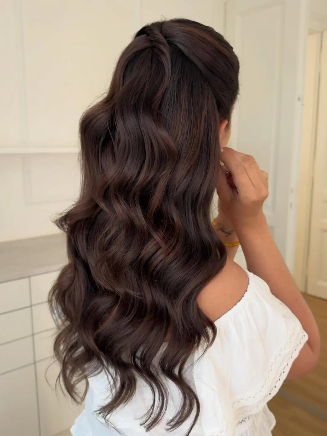 Fall hairstyles for wedding guests 2026 Soft Half-Up Glam Waves with Rich Brunette Shine