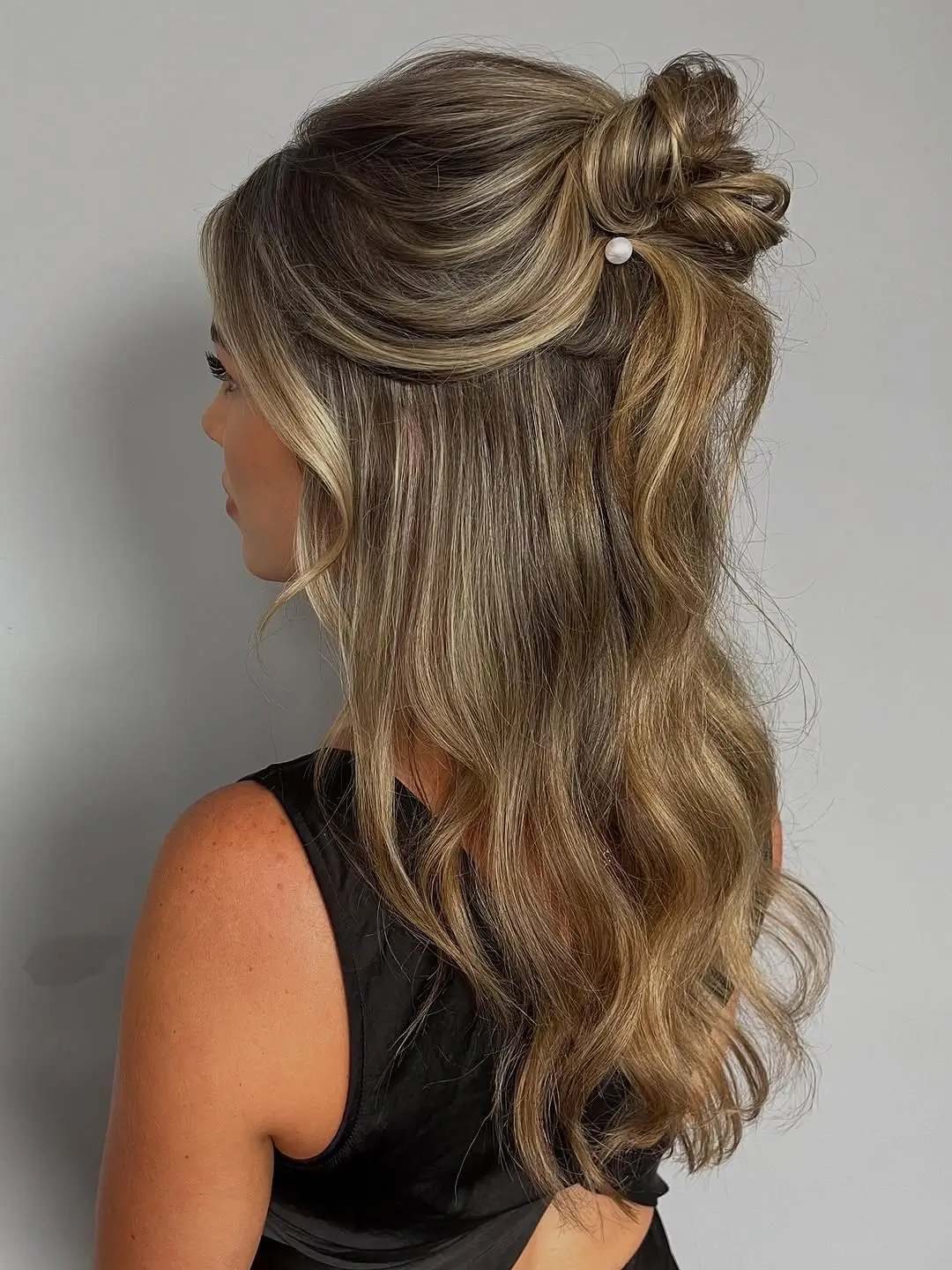 Fall hairstyles for wedding guests 2026 Relaxed Half-Up Knot with Soft Blonde Waves
