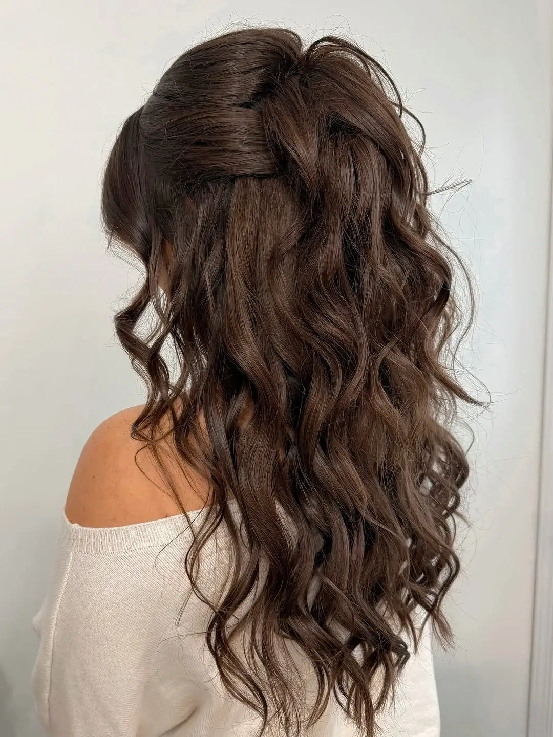 Fall hairstyles for wedding guests 2026 Glossy Cascading Curls with a Soft Half-Up Crown