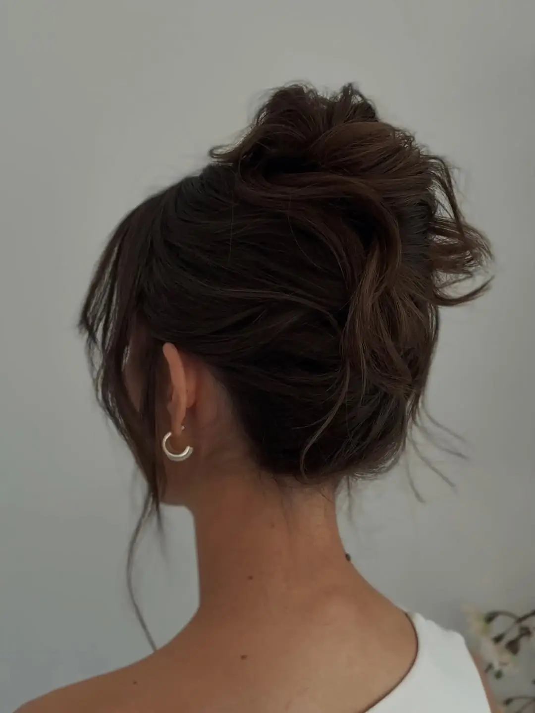 Fall hairstyles for wedding guests 2026 Soft Textured Bun with Relaxed Romantic Volume