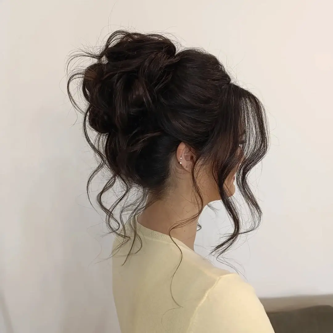 Fall hairstyles for wedding guests 2026 Soft Textured Updo with Face-Framing Curls