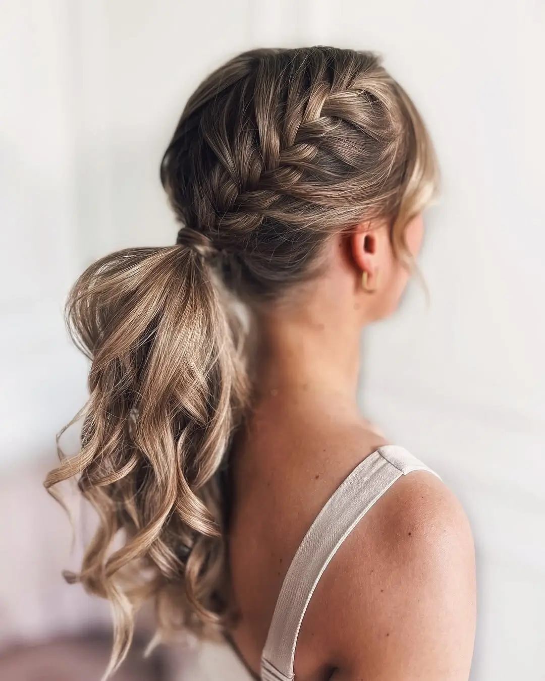 Fall hairstyles for wedding guests 2026 Loose Braided Ponytail with Soft Cascading Curls