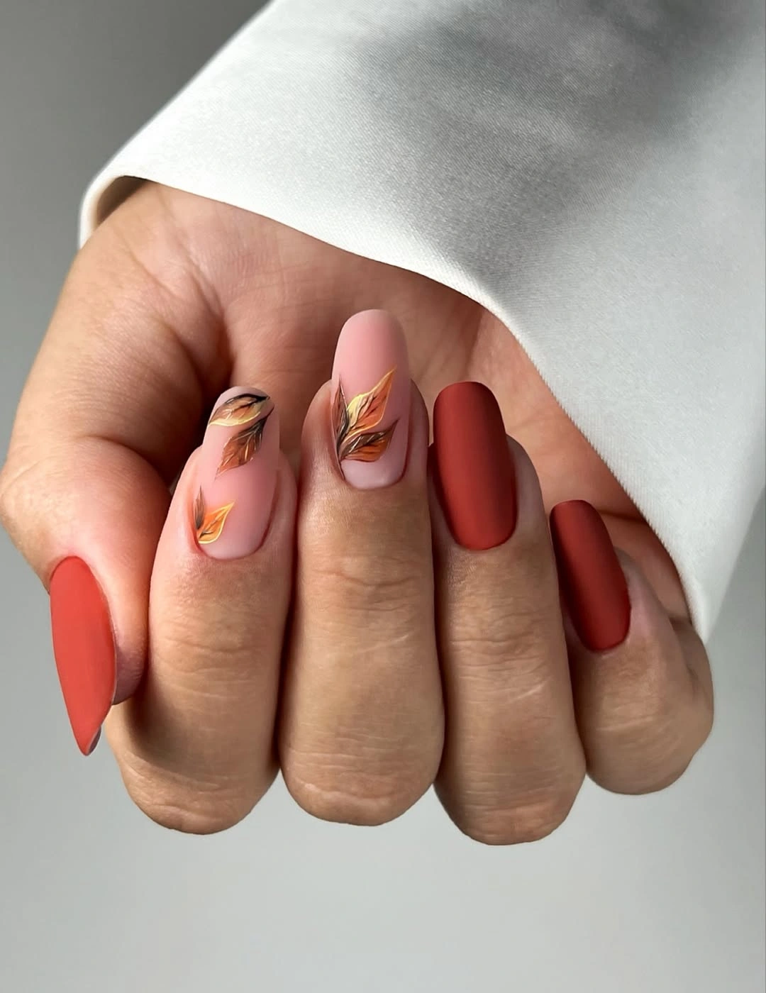 Fall medium nail ideas 2026 Burnt Terracotta Matte Nails With Hand-Painted Autumn Leaves