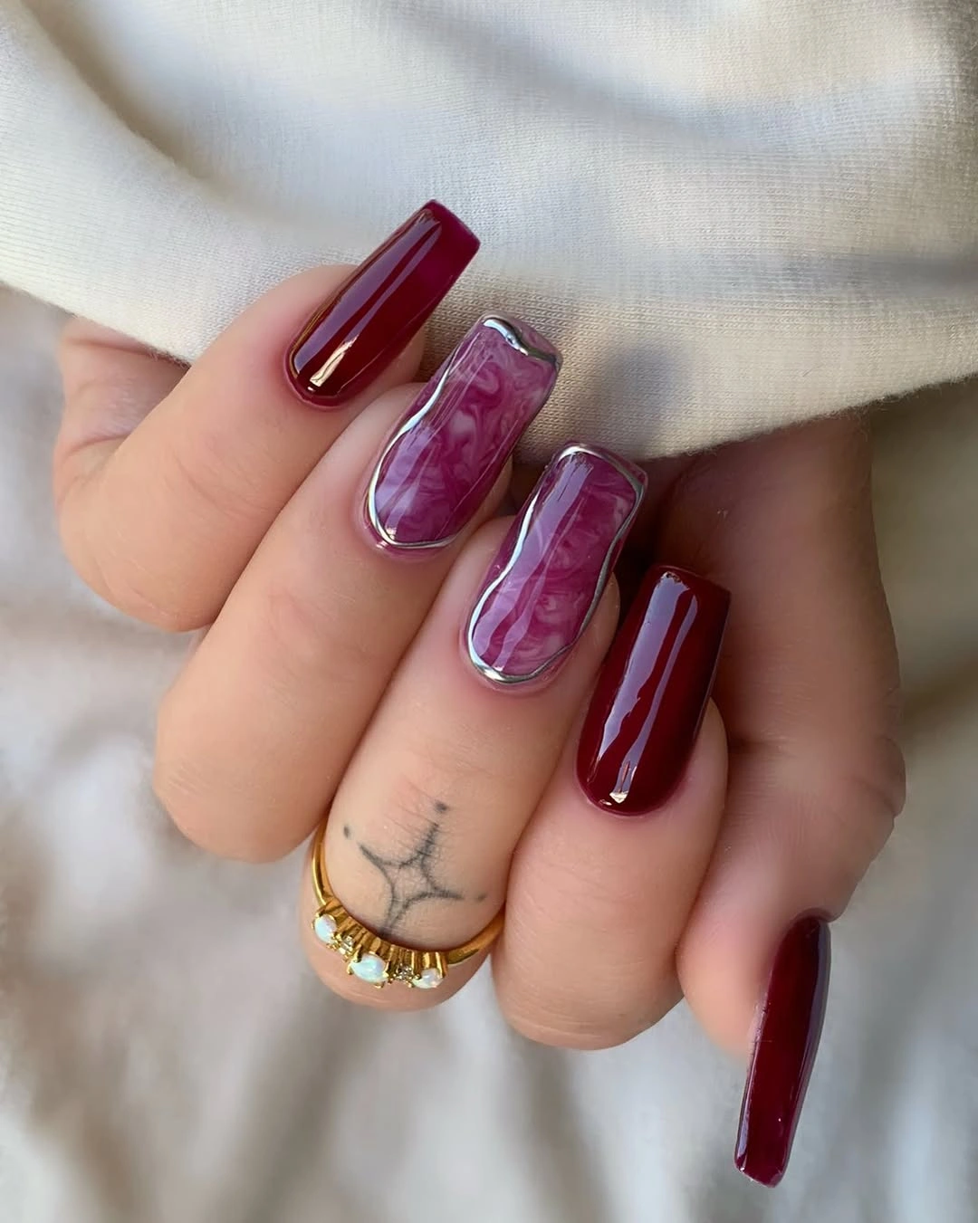 Fall nail art 2026 Deep Burgundy Marble Nails with Metallic Silver Frames
