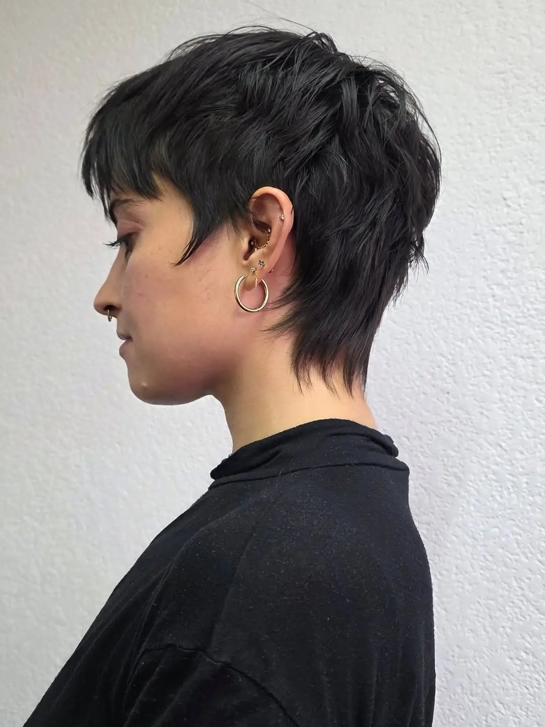 fall pixie haircut ideas 2026 Edgy Black Pixie Mullet With Feathered Layers