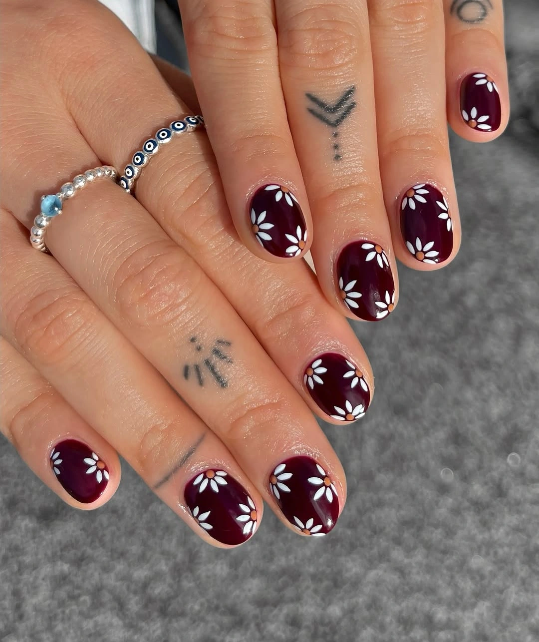 Fall red nails 2026 Short Burgundy Daisy Nails With Vintage Charm