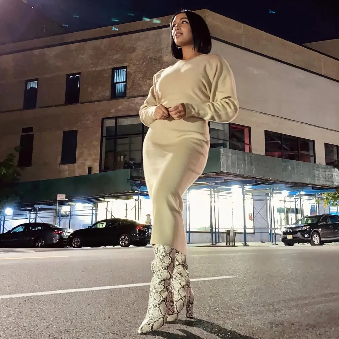 fall sweater dress outfits 2026 A Cream Sweater Dress Styled With Bold Snakeskin Boots