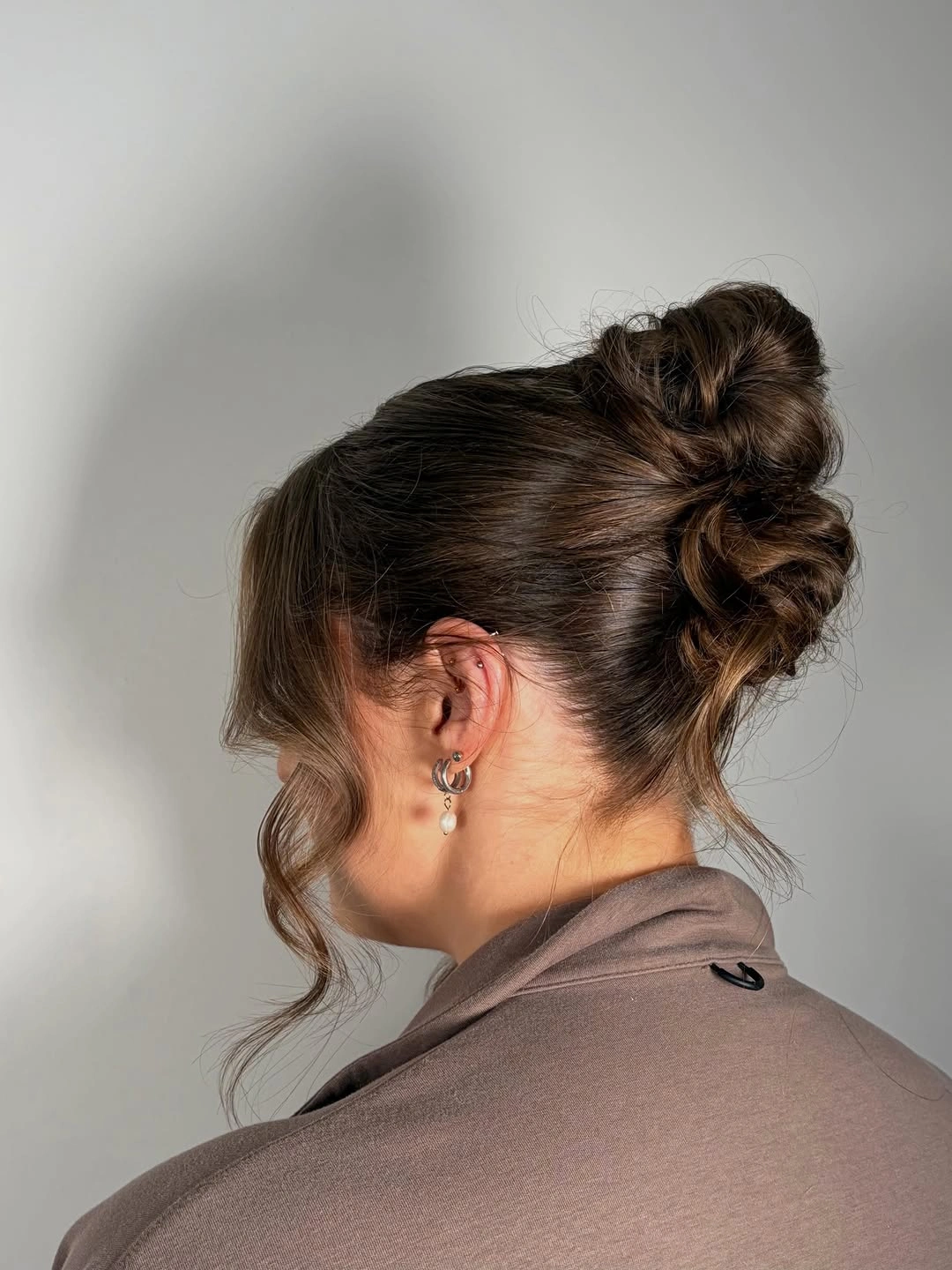 September hairstyles ideas 2026 Soft Textured Bun with Romantic Face-Framing Pieces