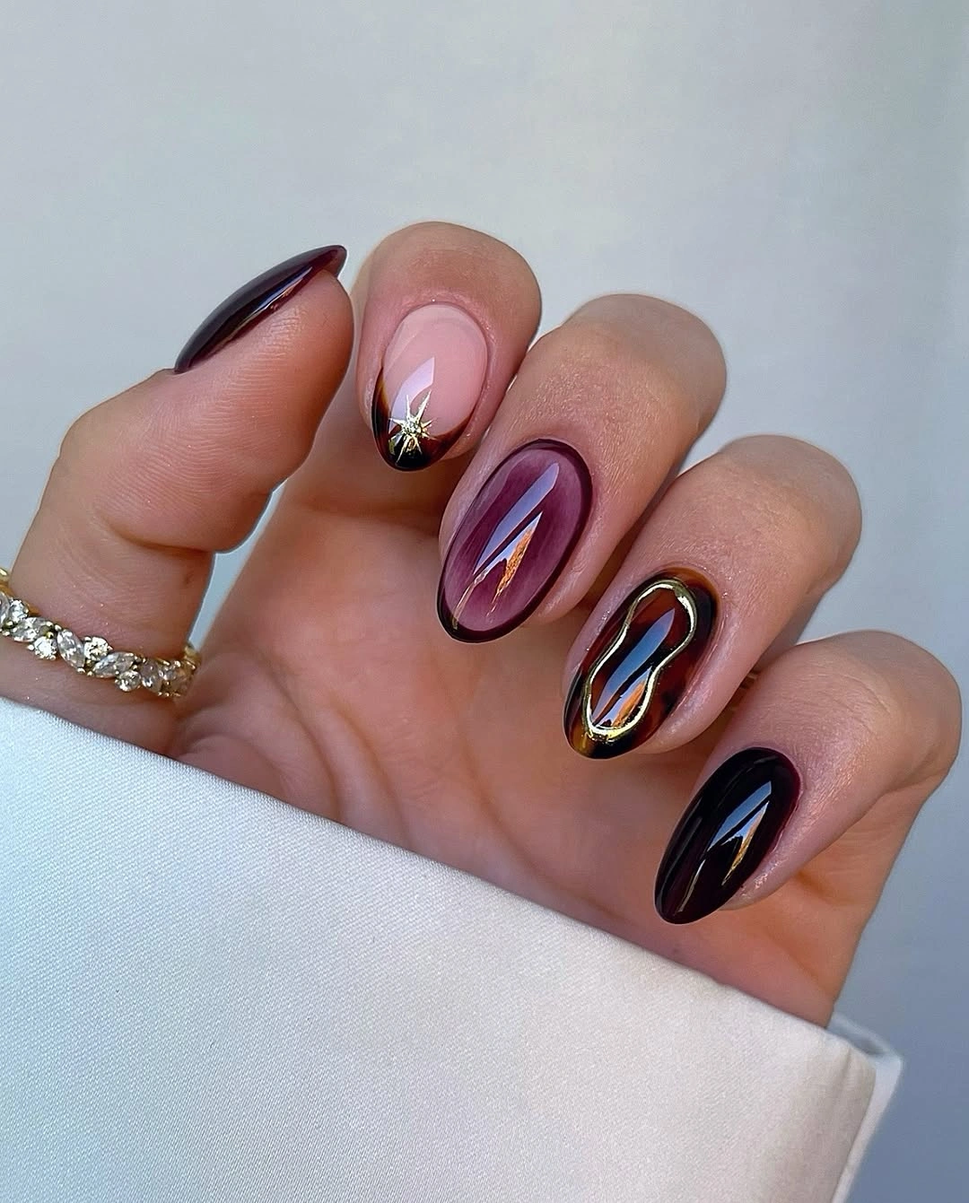 September Nail Art Ideas 2026 Smoky Plum Glass Nails with Luxurious Gold Details