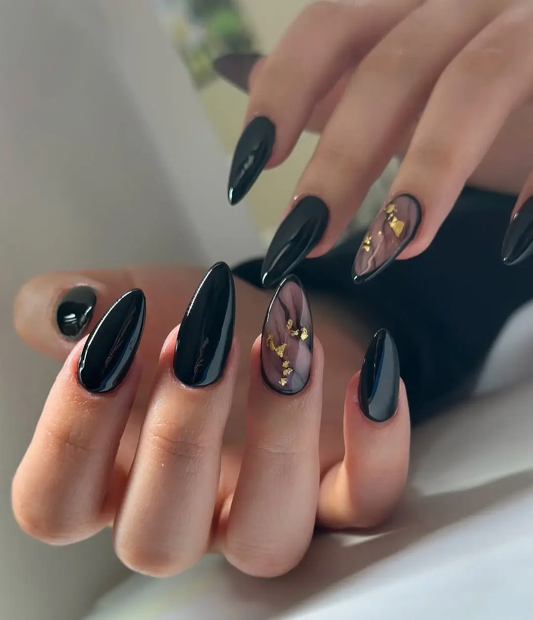 Dark fall nails 2026 Glossy Black Marble Nails With Soft Gold Accents