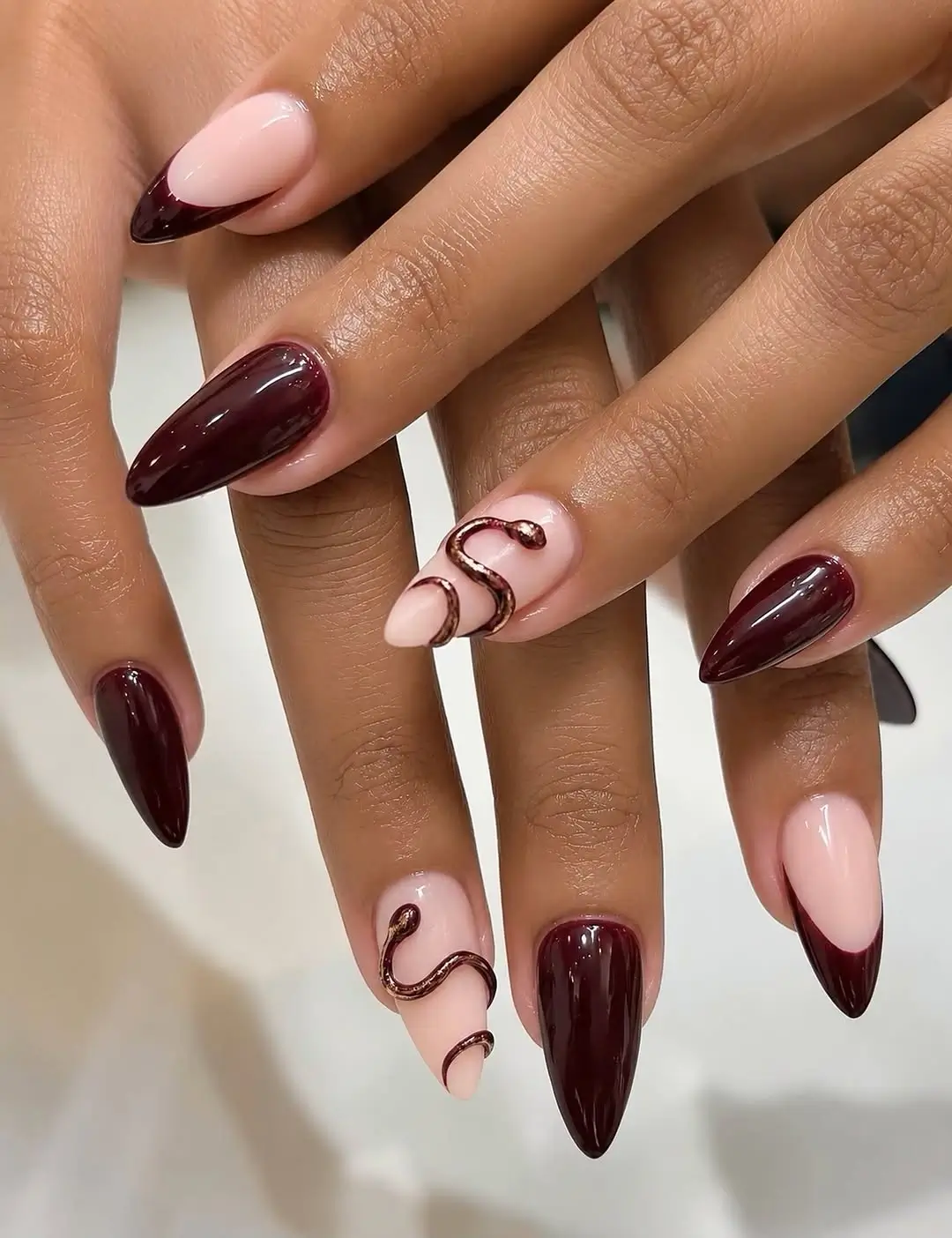 fall burgundy nails with design Deep burgundy almond nails with metallic swirls
