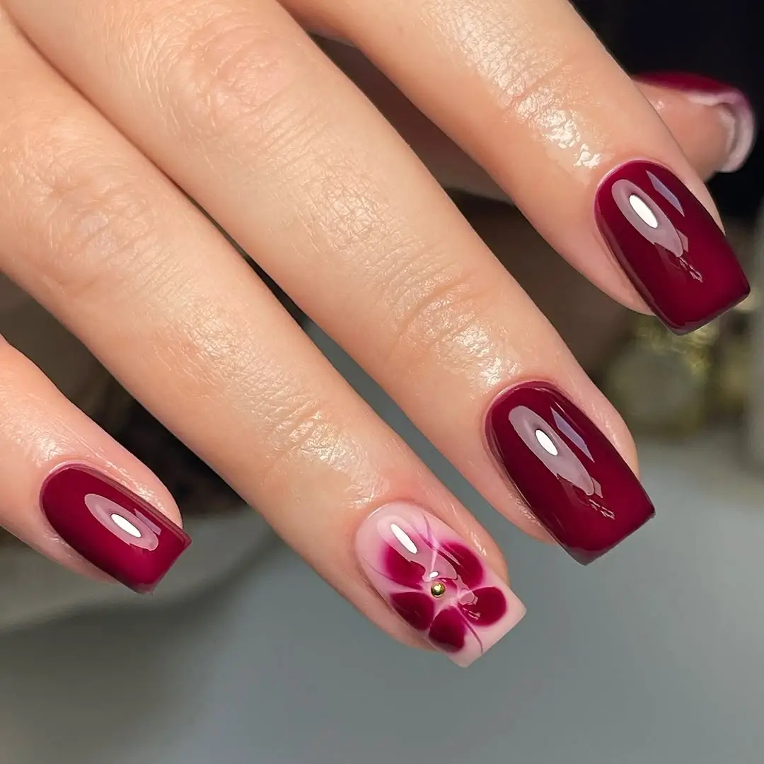fall burgundy nails with design Glossy burgundy manicure with floral accent