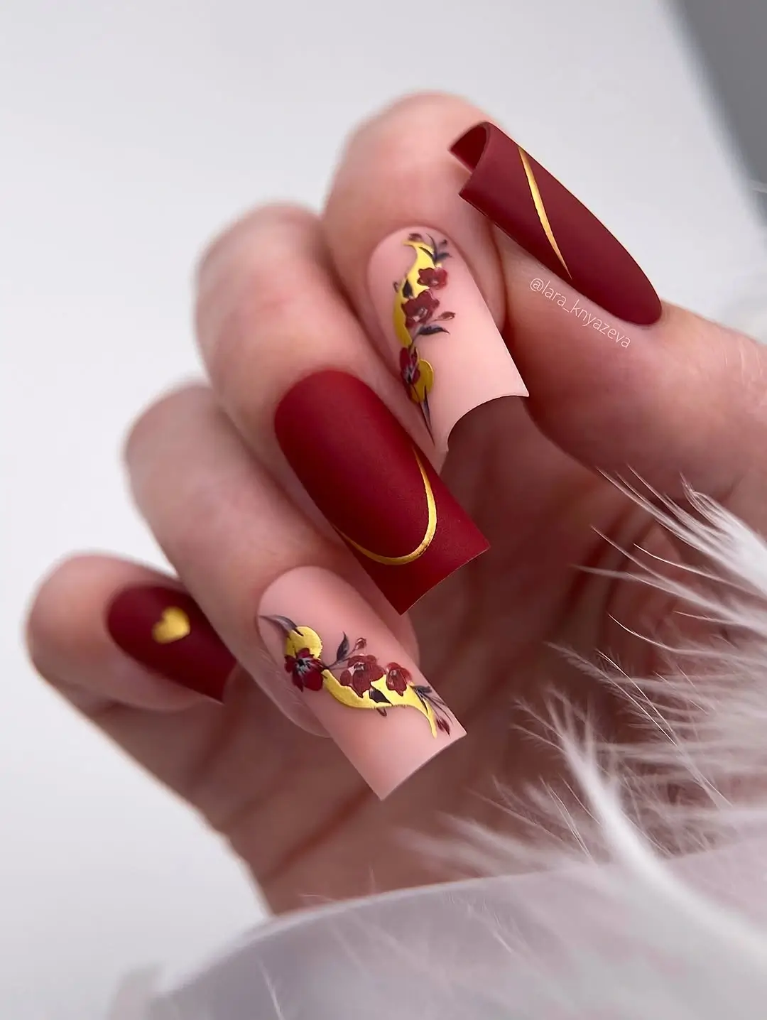fall long nails 2026 burgundy nails with gold botanical details