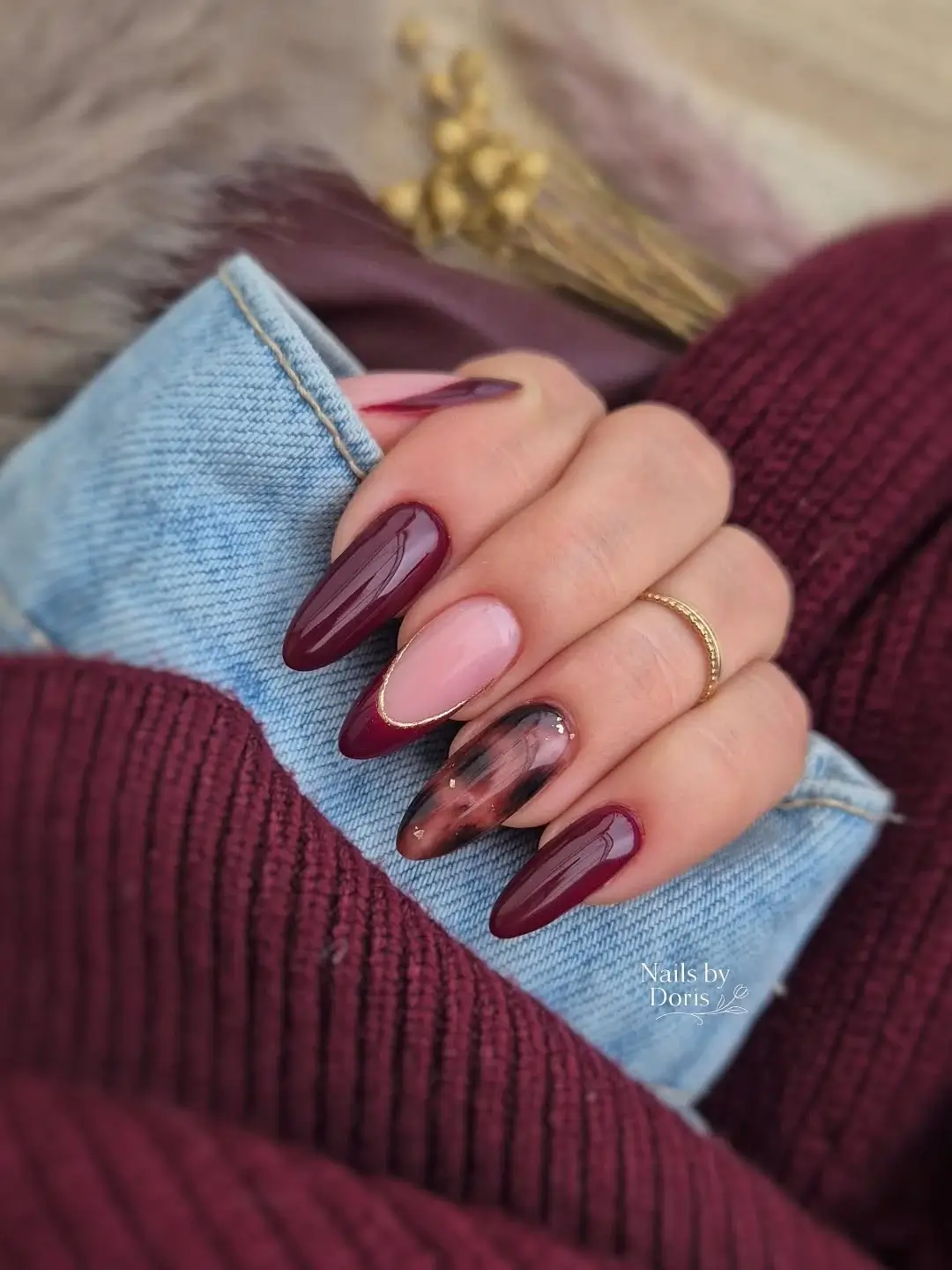 fall nail trends 2026 Deep Wine Marble Nails with Golden Outline Details