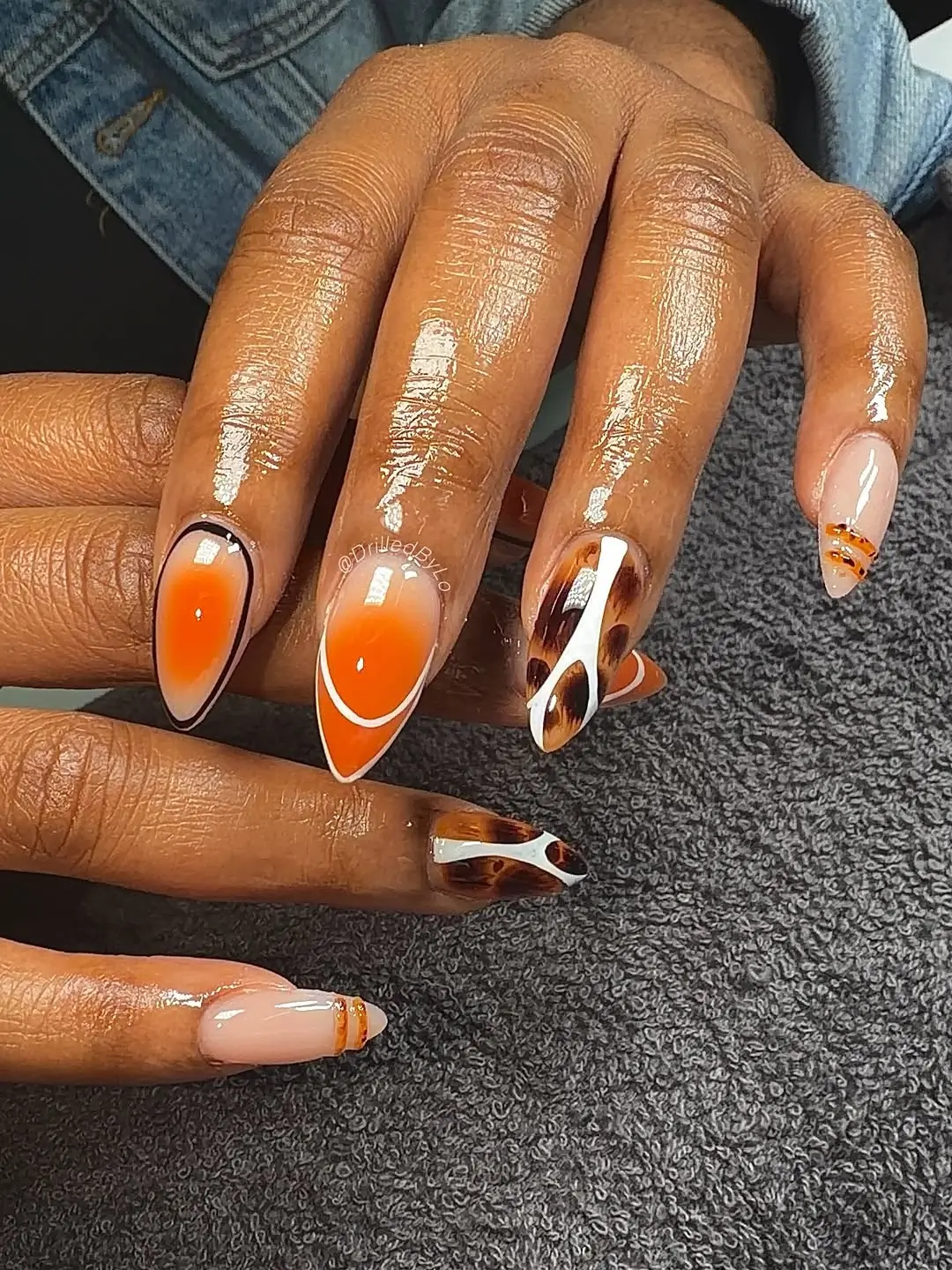 Fall nails for dark skin 2026 Pumpkin Orange and Tortoiseshell Nails With Retro Flair