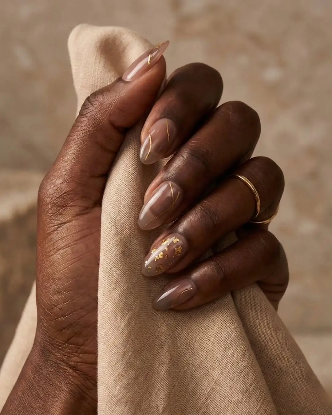 Fall nails for dark skin 2026 Soft Taupe Nails With Delicate Gold Foil Elegance