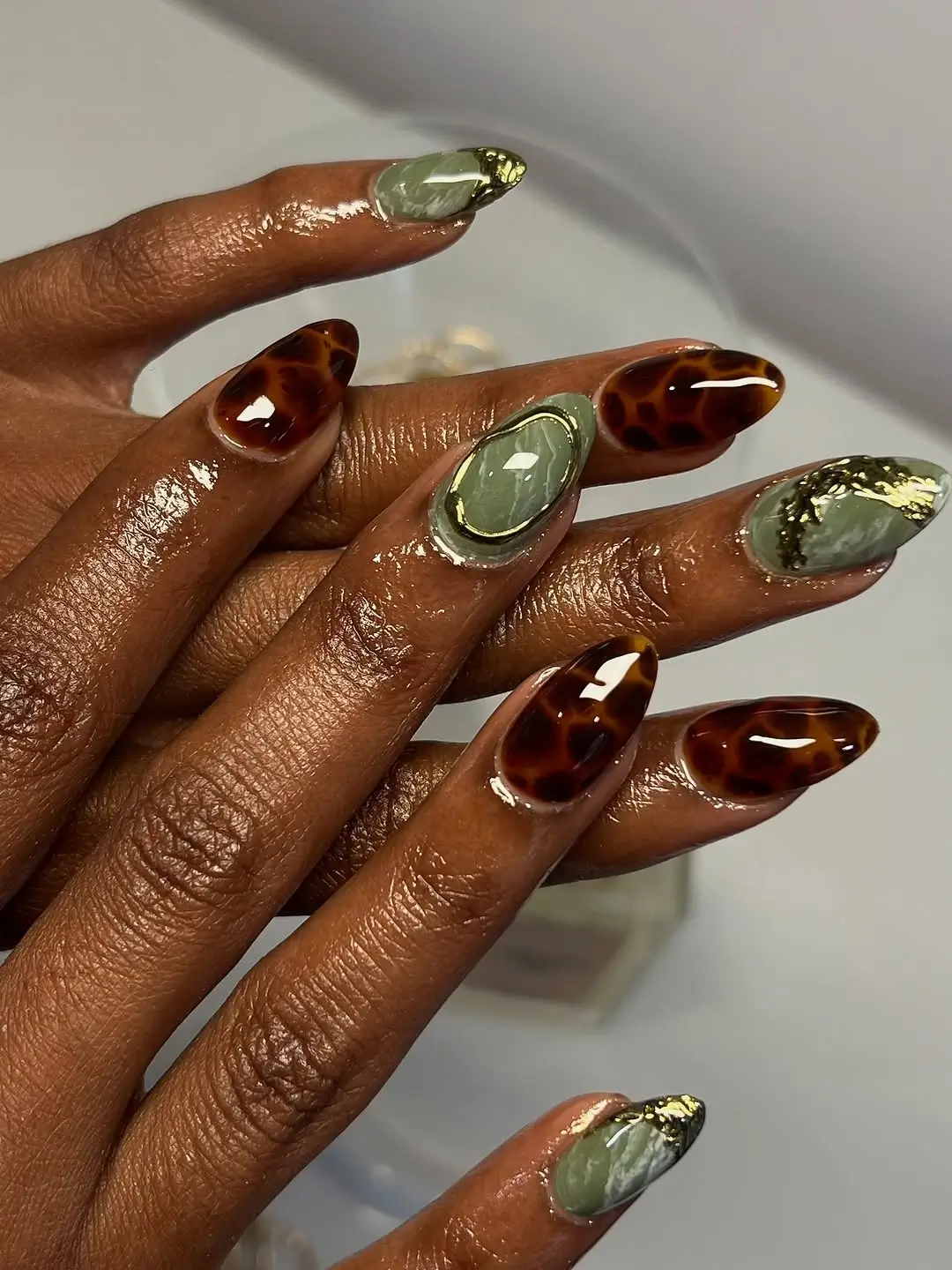 Fall nails for dark skin 2026 Olive Stone Nails With Tortoiseshell and Gold Accents