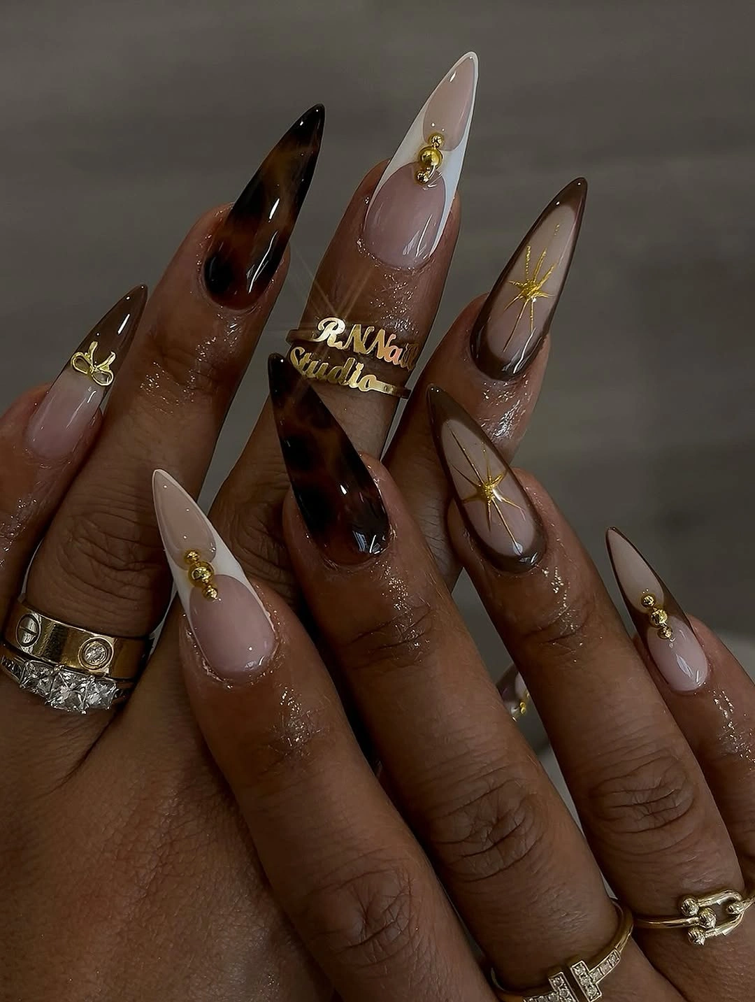 fall nails for tan skin tone chocolate stiletto nails with gold design