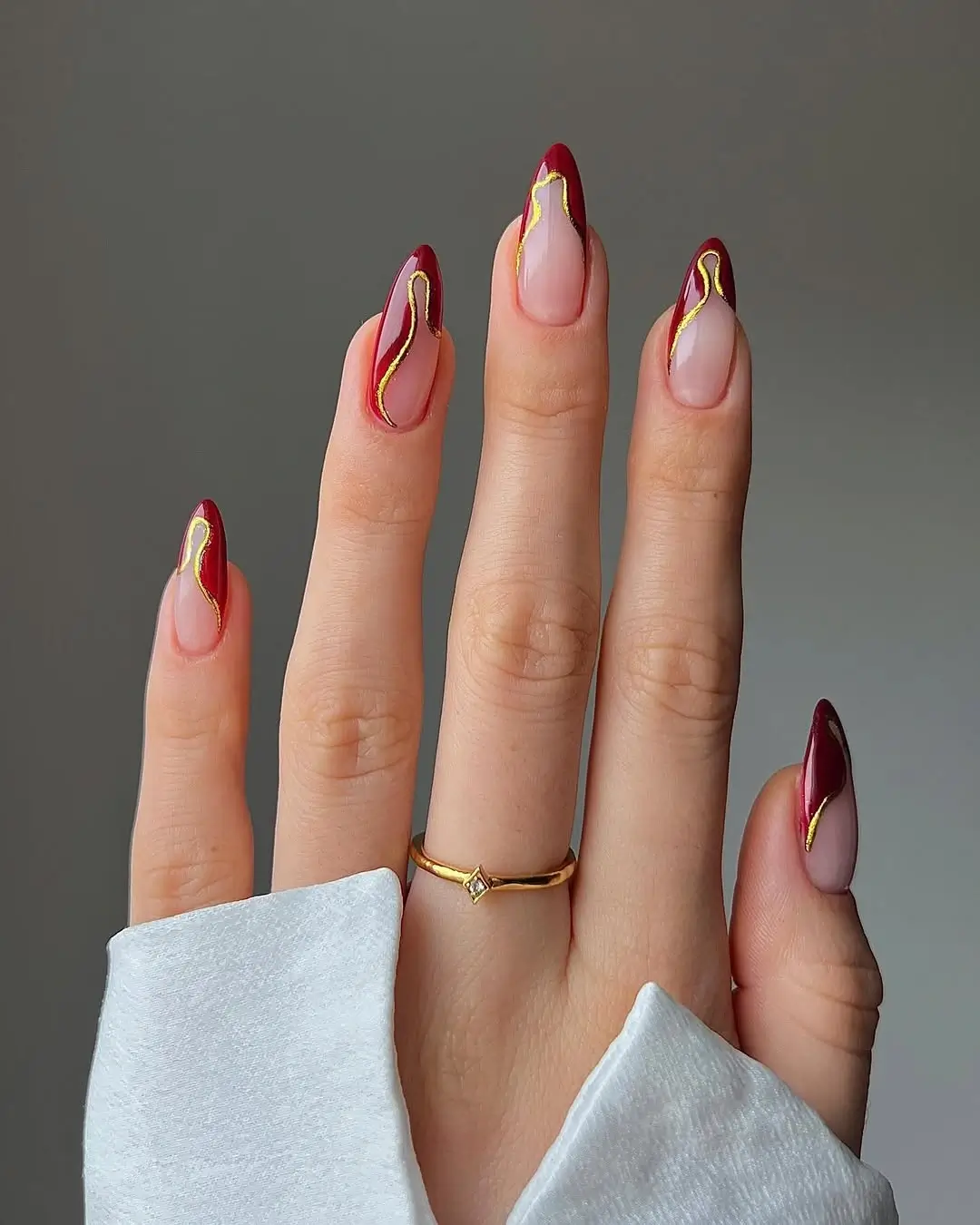 Fall short almond nails 2026 Modern Burgundy Waves with Gold Accents