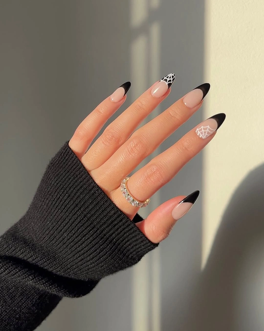fall trendy nails 2026 black French tip almond nails with spiderweb art