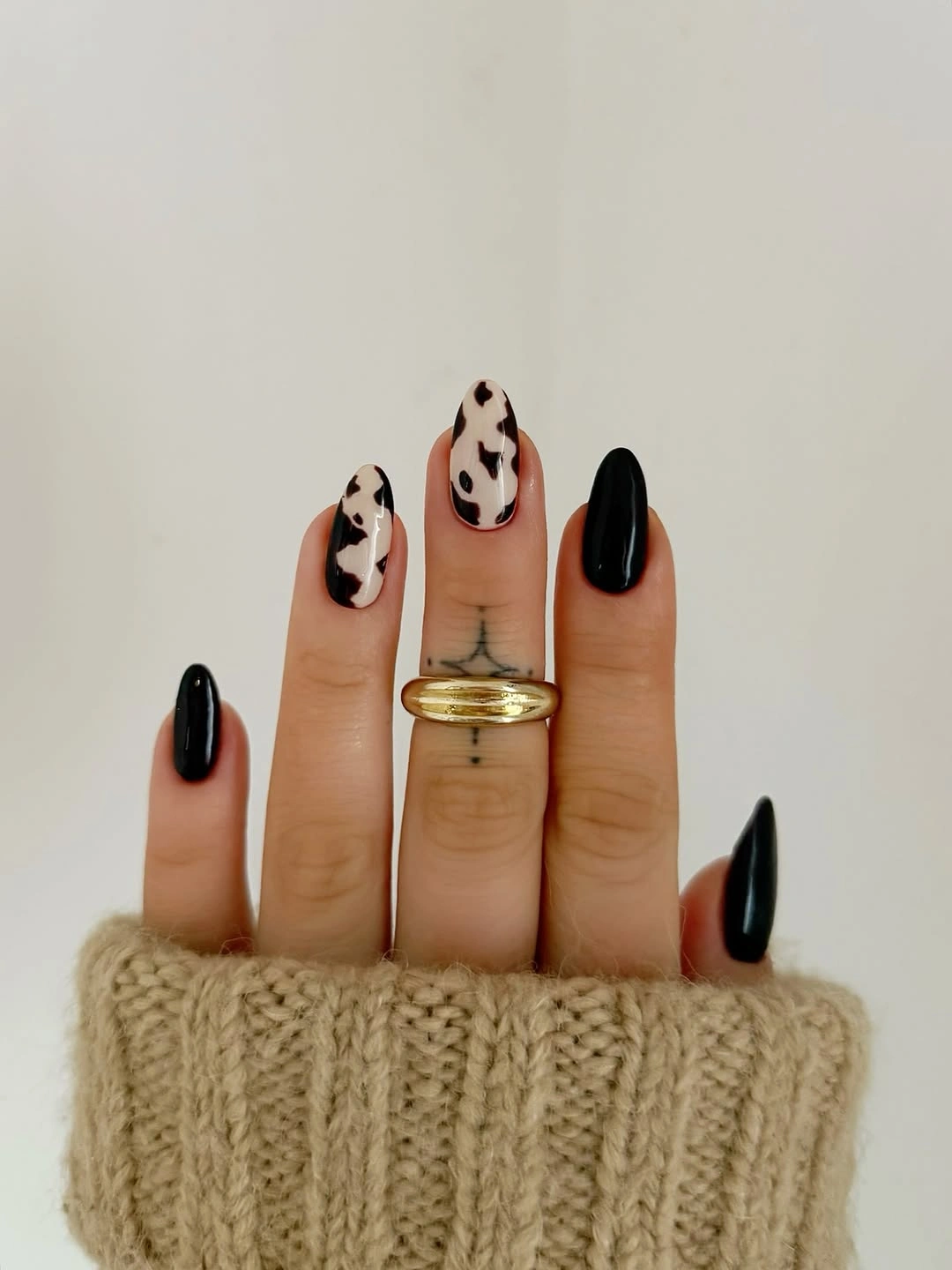 fall trendy nails 2026 black and cow print almond nails