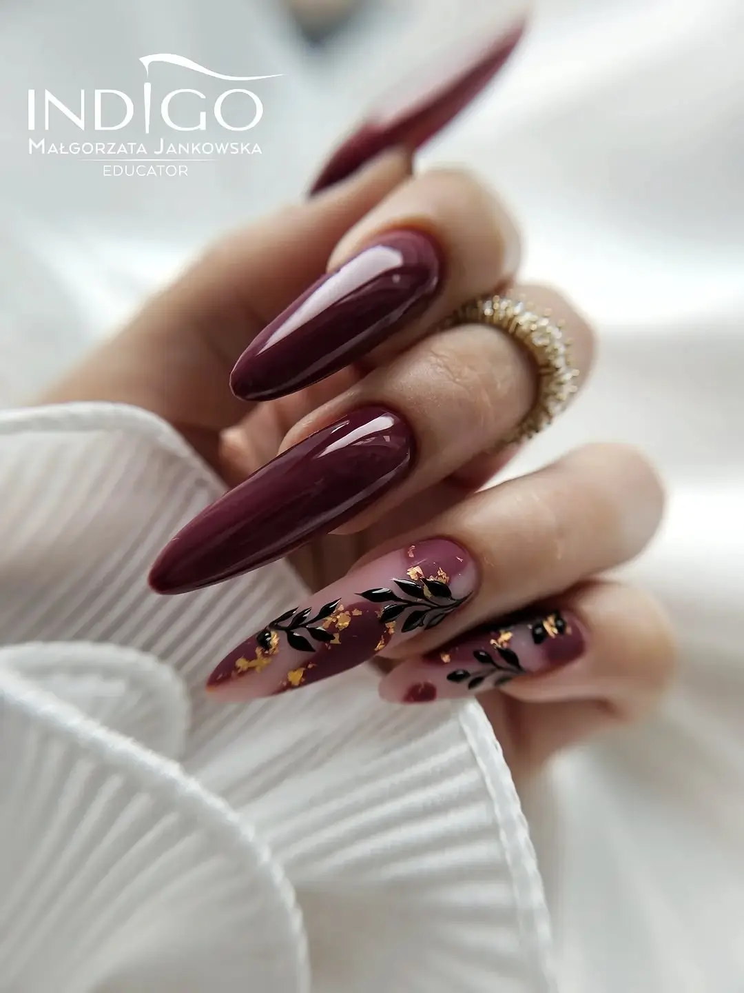 fall trendy nails 2026 plum almond manicure with black leaves and gold foil