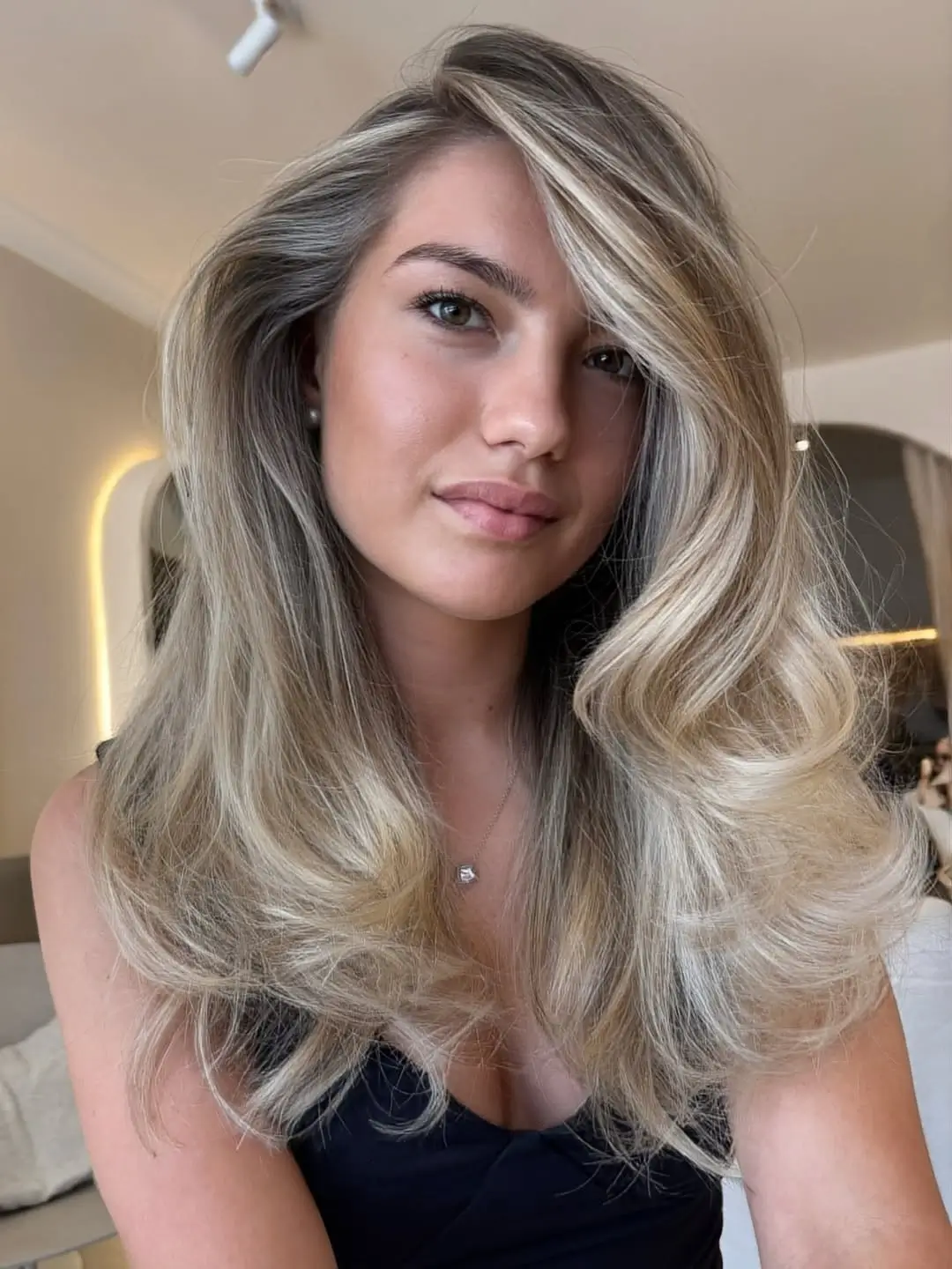 middle parting hairstyles Soft Blonde Waves With a Relaxed Center Part