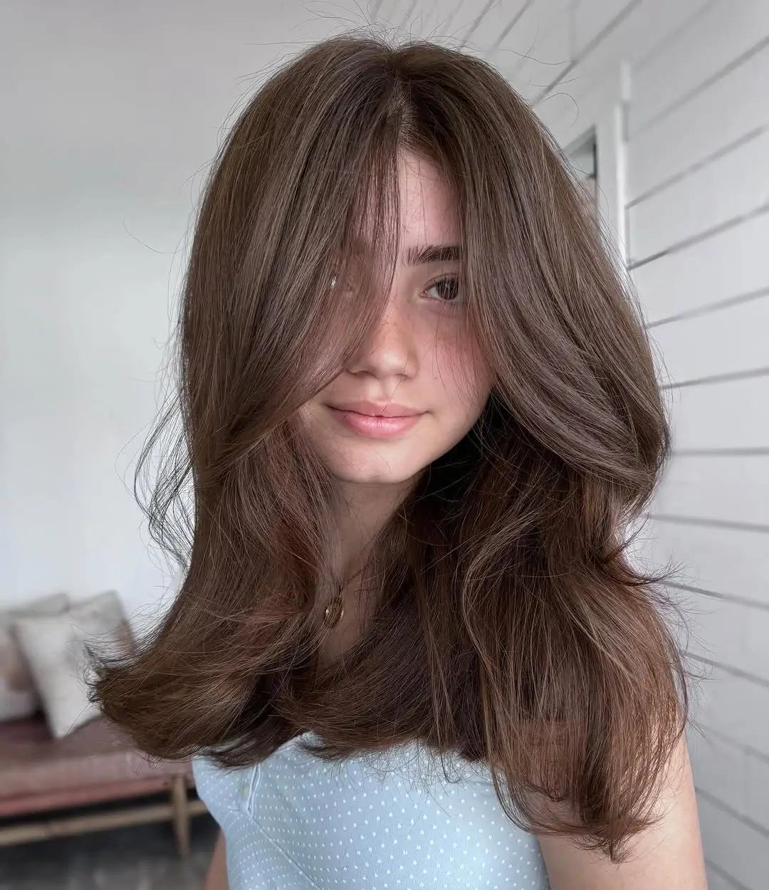 middle parting hairstyles Voluminous Brown Layers With a Soft Center Part