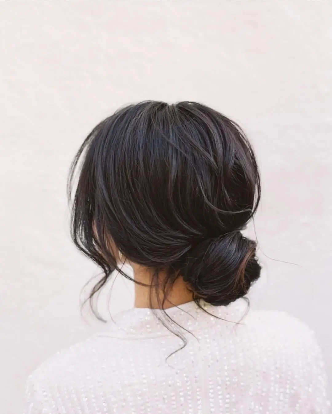 middle parting hairstyles Low Sculpted Bun With Loose Face-Framing Pieces