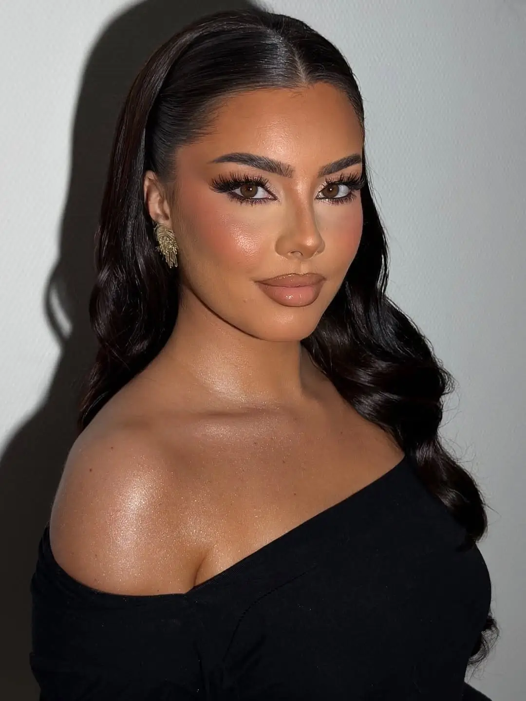 middle parting hairstyles Glossy Black Waves With a Sleek Center Part
