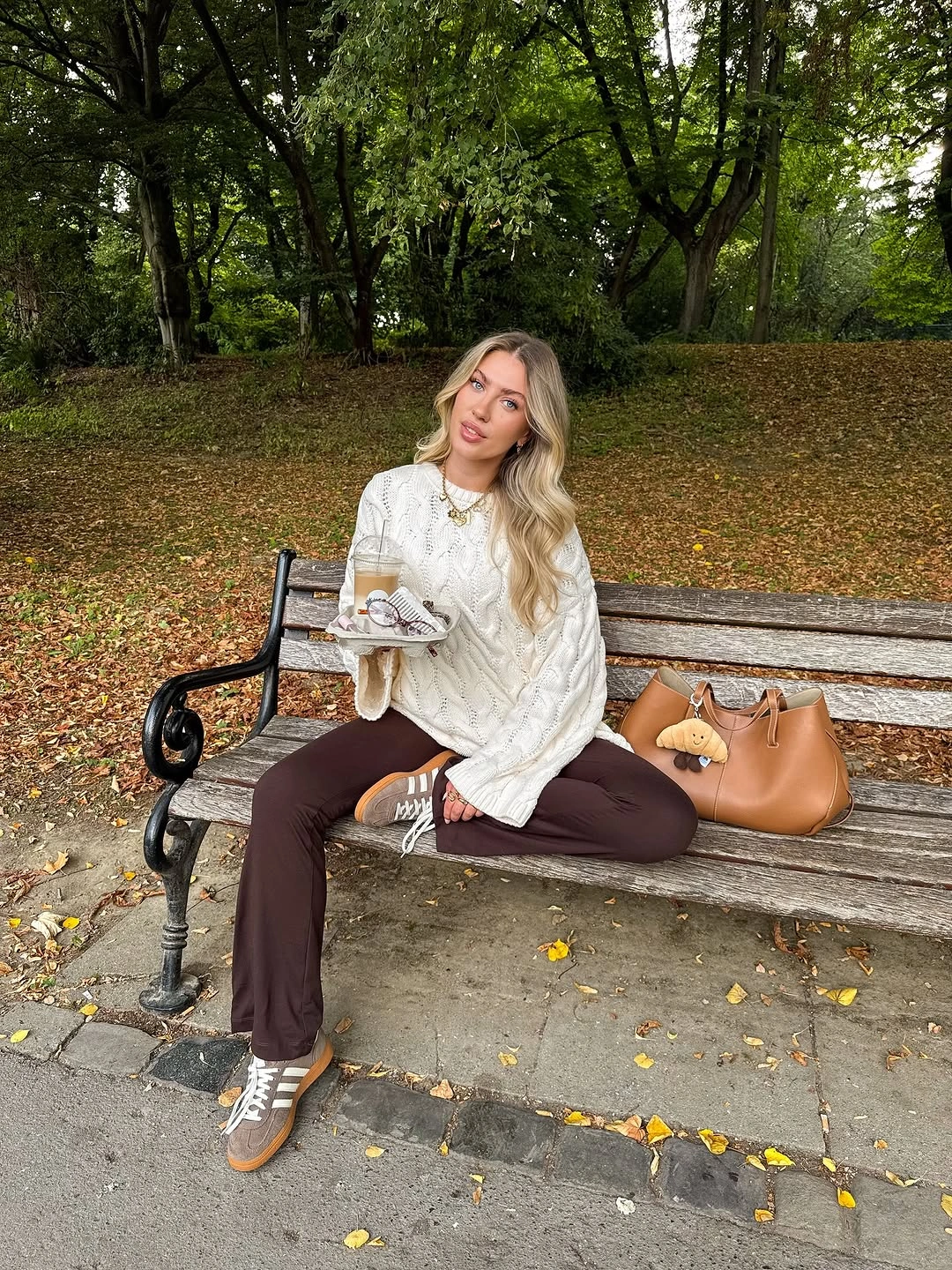 September fashion trends 2026 ivory cable knit sweater and brown trousers