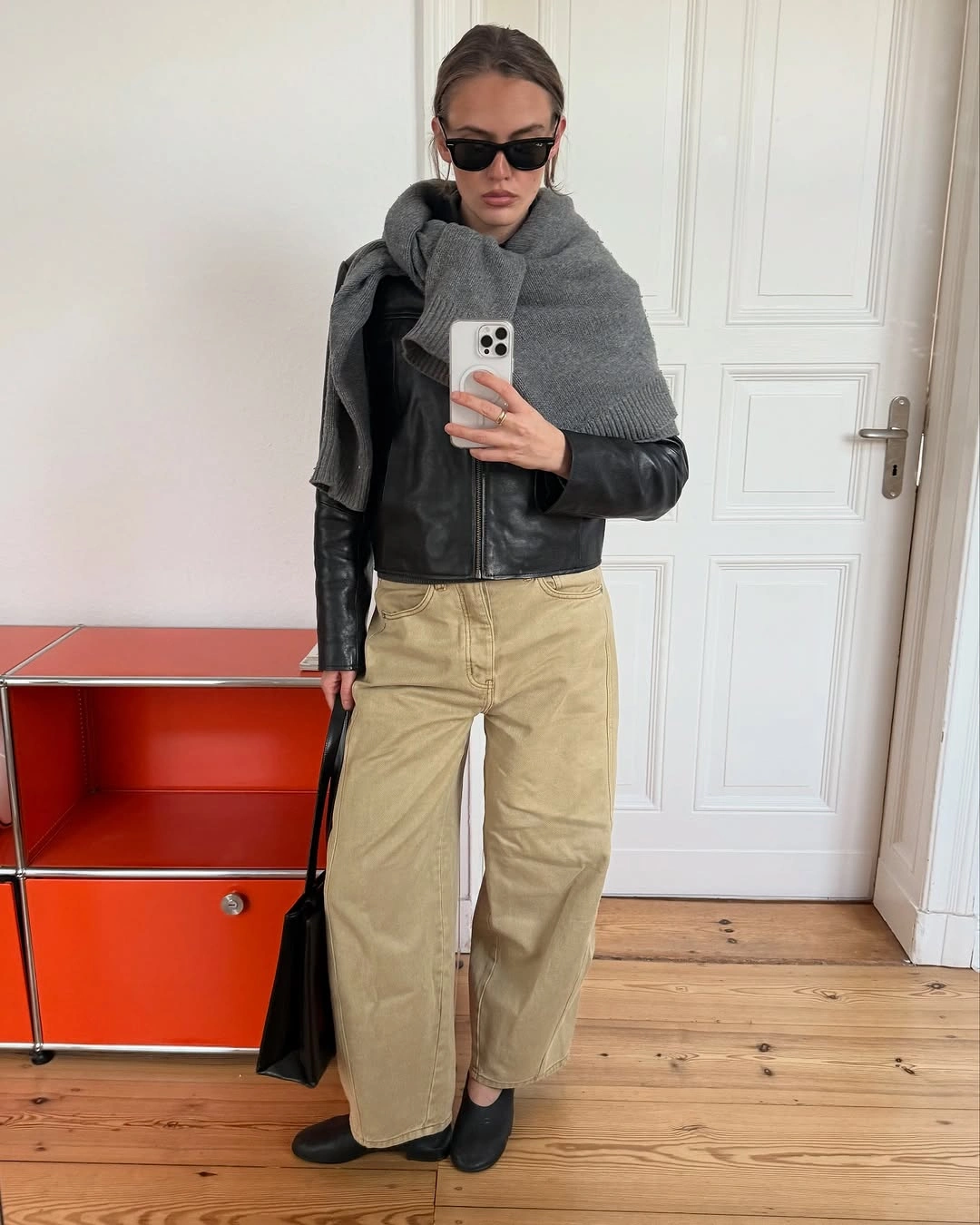 September fashion trends 2026 leather jacket gray sweater and beige trousers