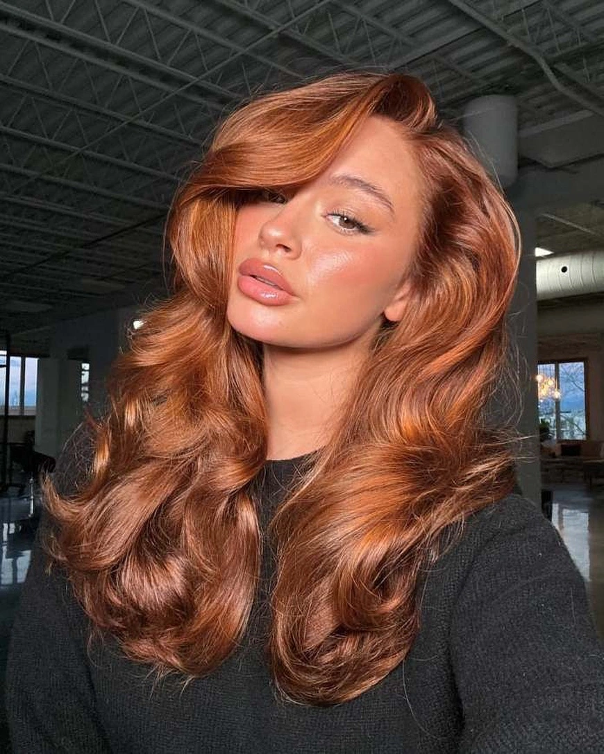 September hair Colour trends 2026 glossy copper waves with vintage side swept layers