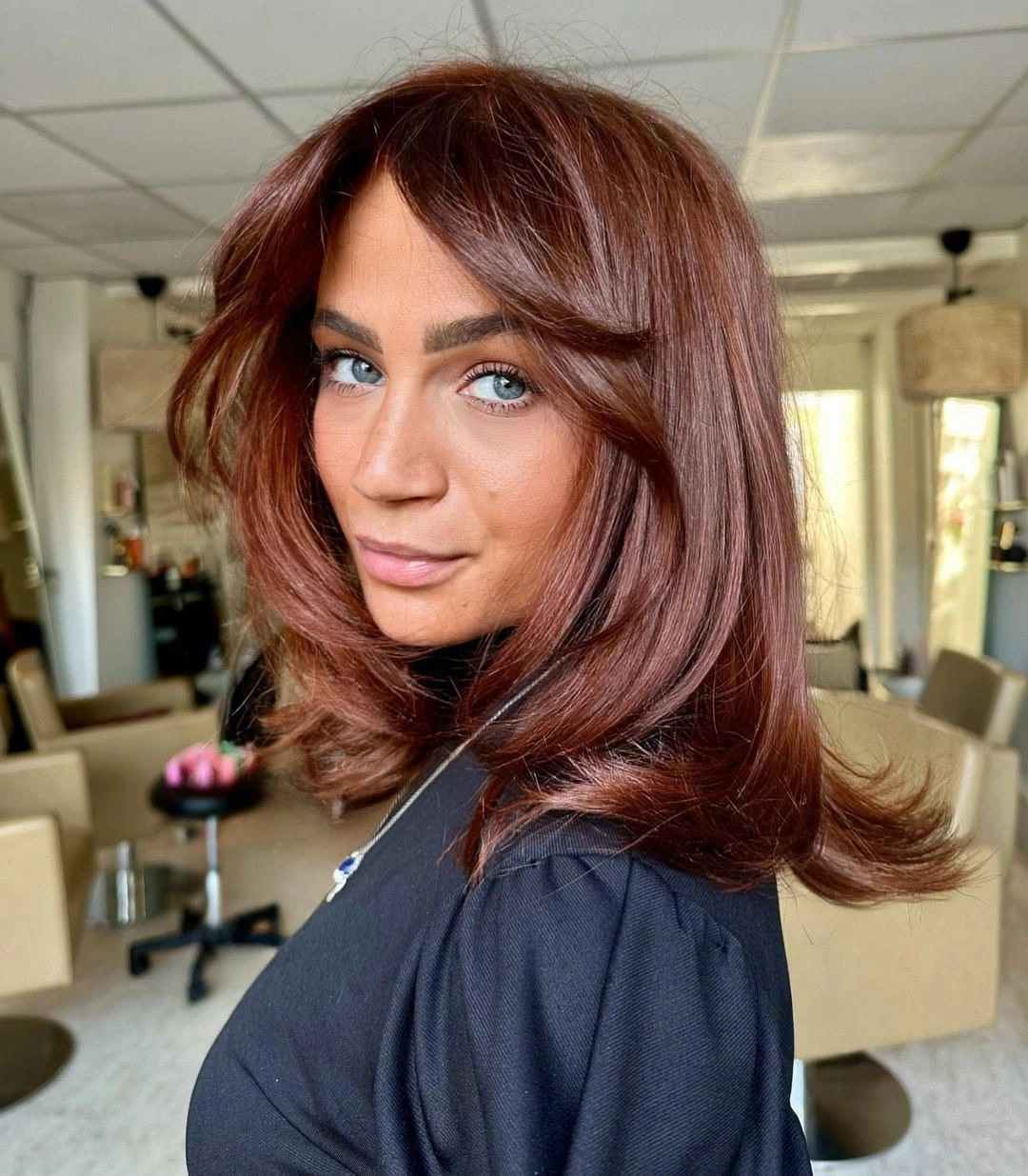 September hair Colour trends 2026 glossy chestnut brown with feathered volume
