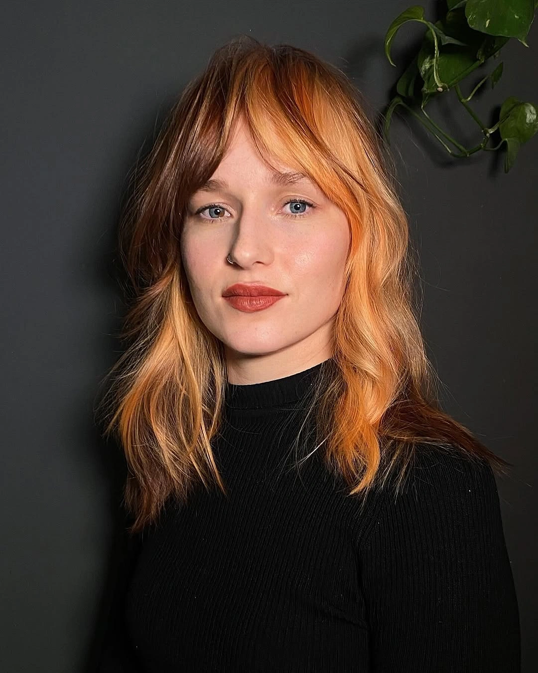 September hair Colour trends 2026 burnt orange and deep brown with soft bangs