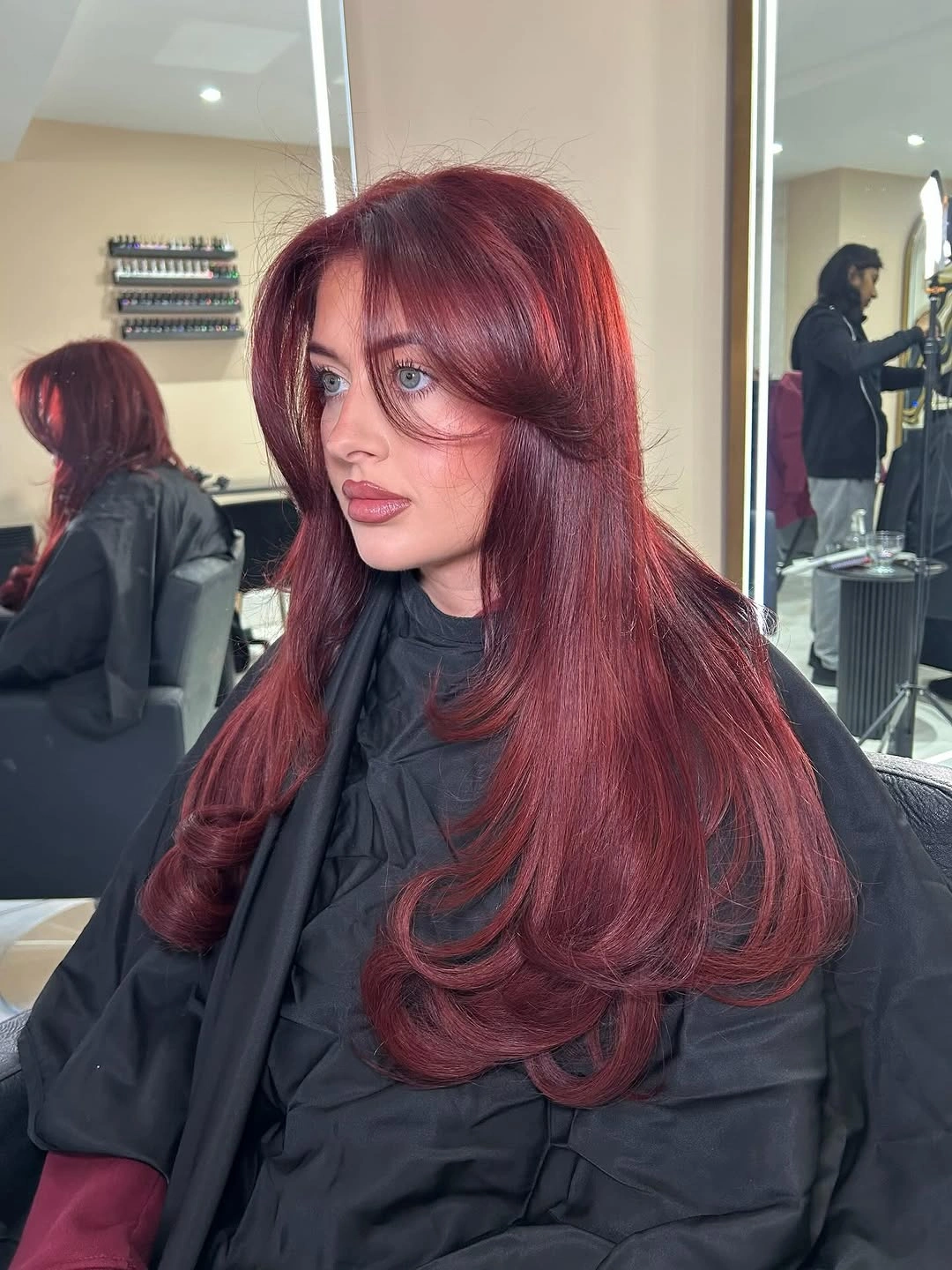 September hair Colour trends 2026 deep berry red with voluminous butterfly layers