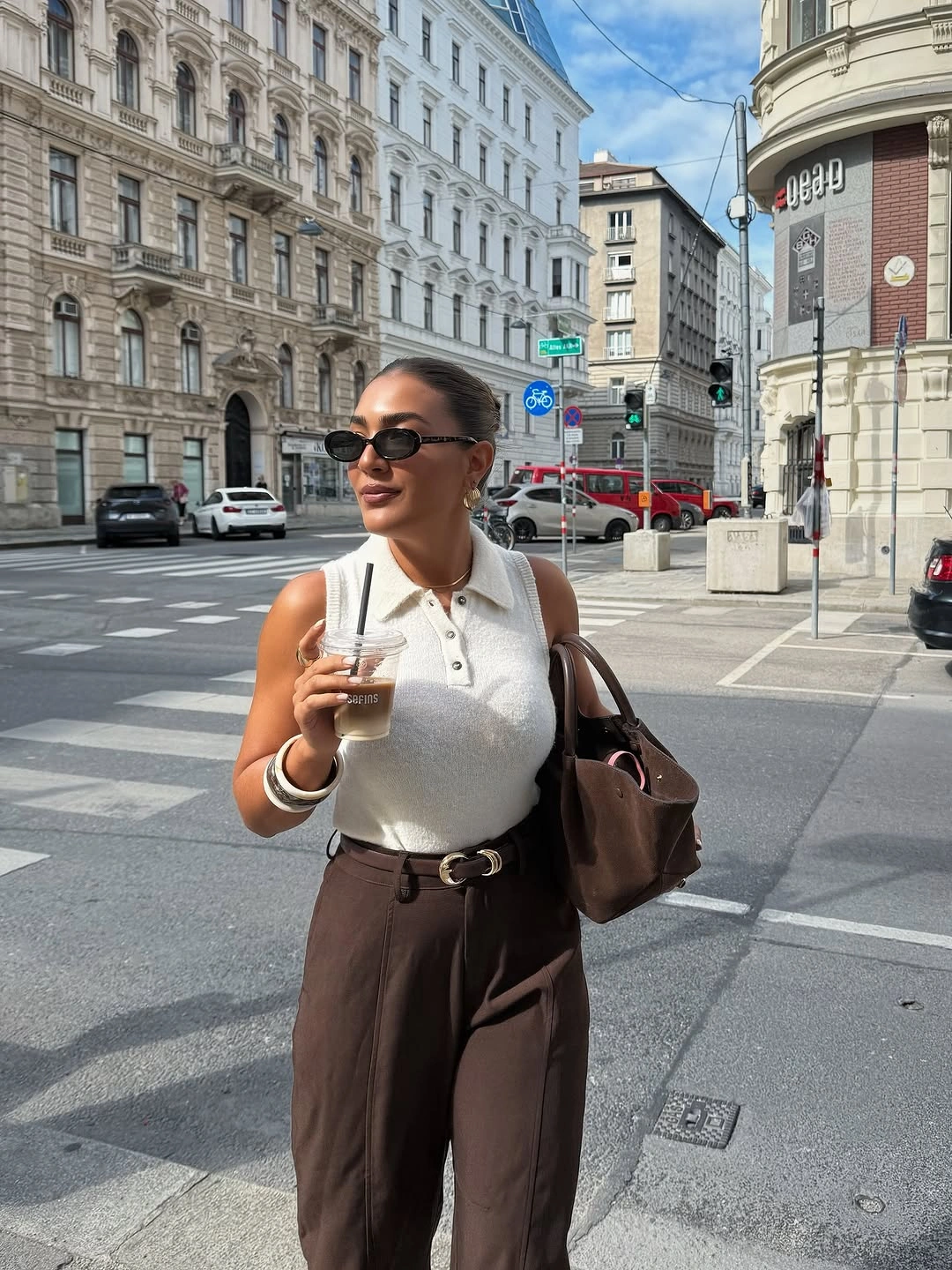 September outfit ideas 2026 Ivory knit polo and chocolate trousers for warm September days